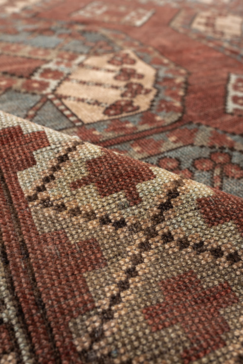7' x 9' one-of-a-kind handmade vintage Afghan rug. Color palette: terracotta, ivory, blue gray, rust, taupe, camel, brown