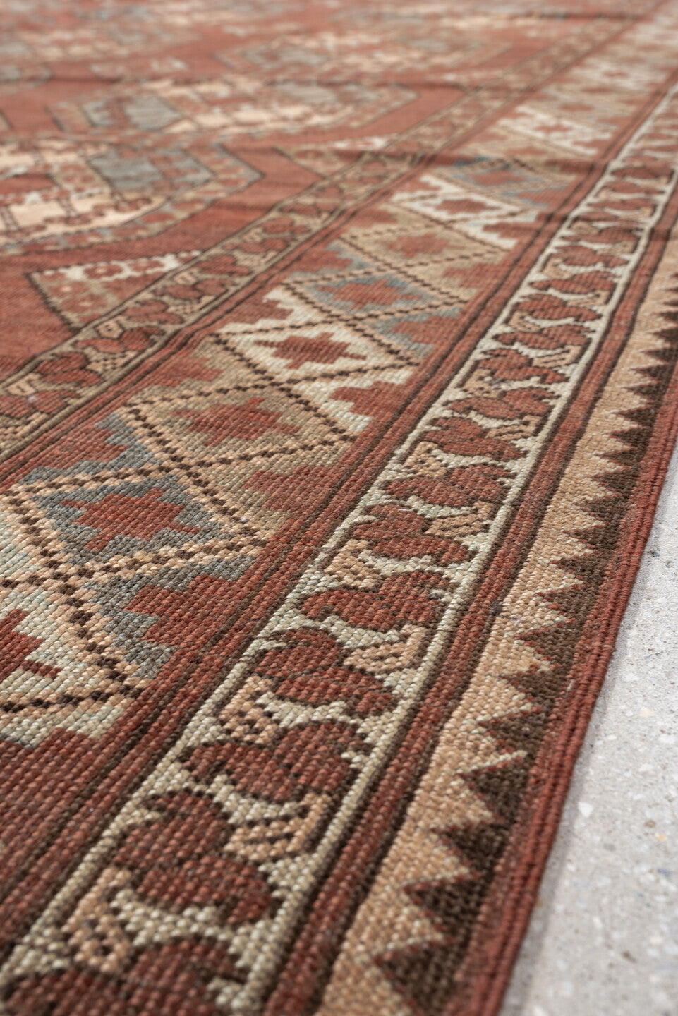7' x 9' one-of-a-kind handmade vintage Afghan rug. Color palette: terracotta, ivory, blue gray, rust, taupe, camel, brown