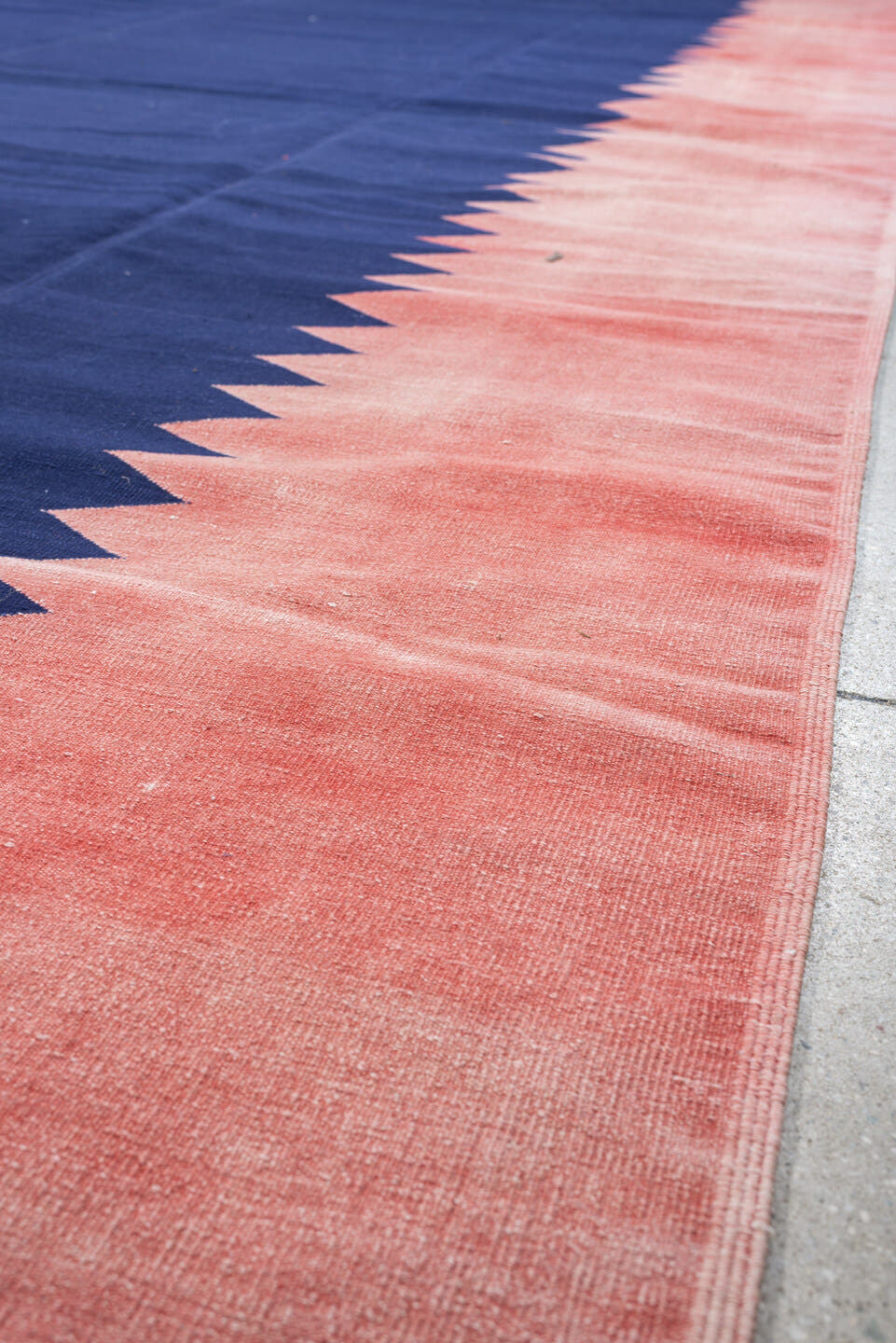 9' x 15' one-of-a-kind handmade antique Cot Dhurrie rug. Color palette: indigo, coral, rose, navy, ivory, purple, terracotta