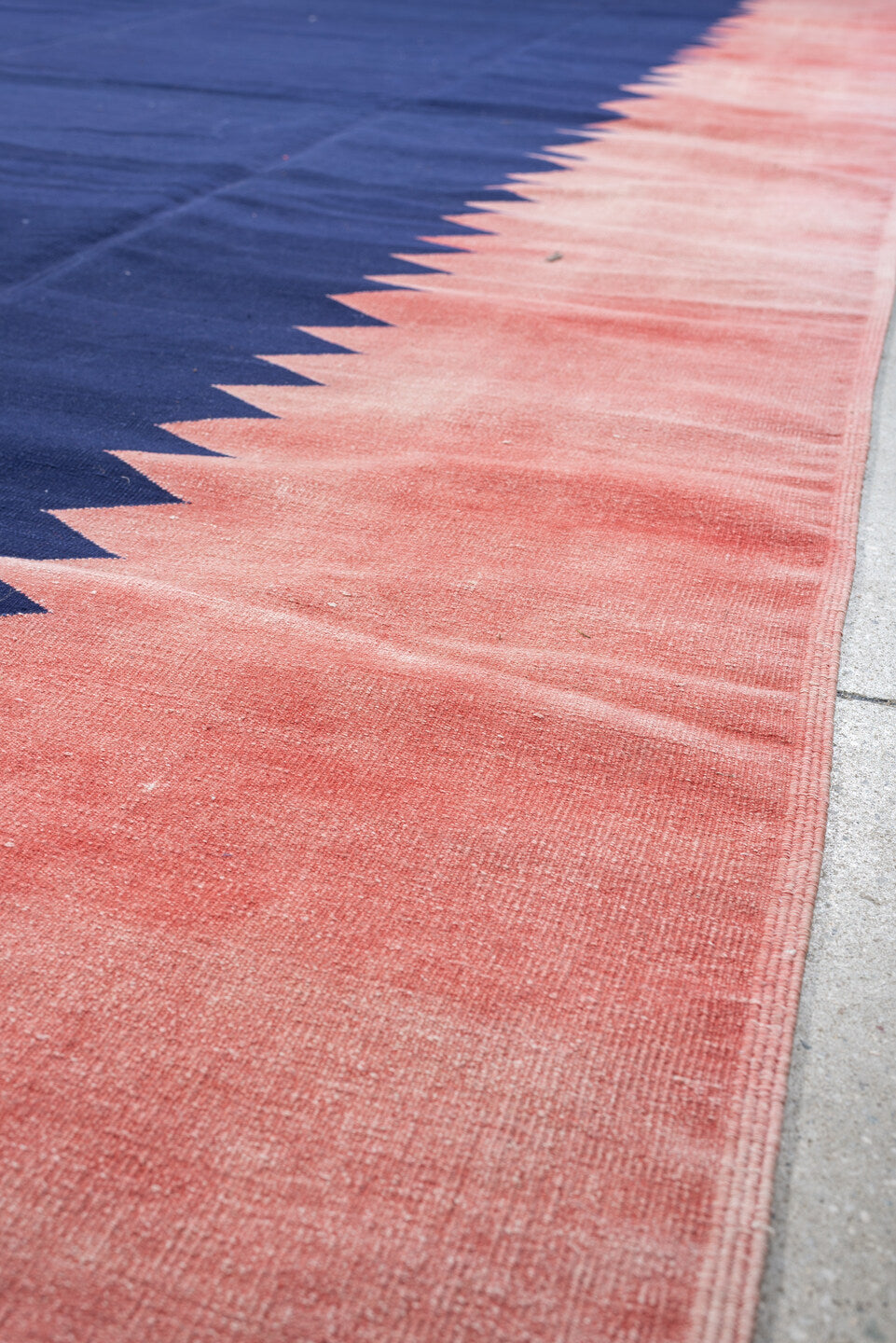 9' x 15' one-of-a-kind handmade antique Cot Dhurrie rug. Color palette: indigo, coral, rose, navy, ivory, purple, terracotta