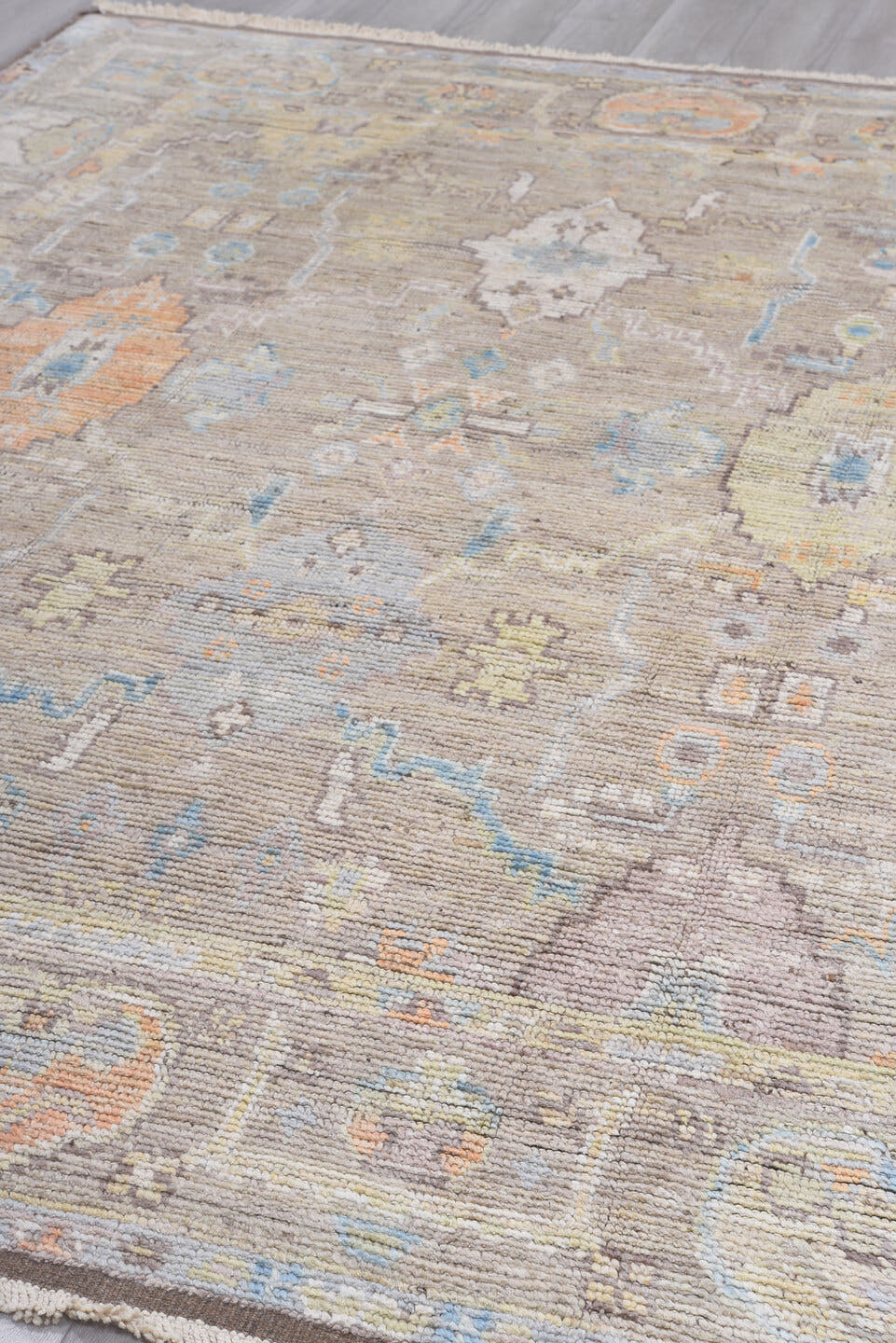 8' x 9' one-of-a-kind handmade vintage Tulu rug. Color palette: taupe, ivory, pale blue, beige, gold, blush, gray, camel
