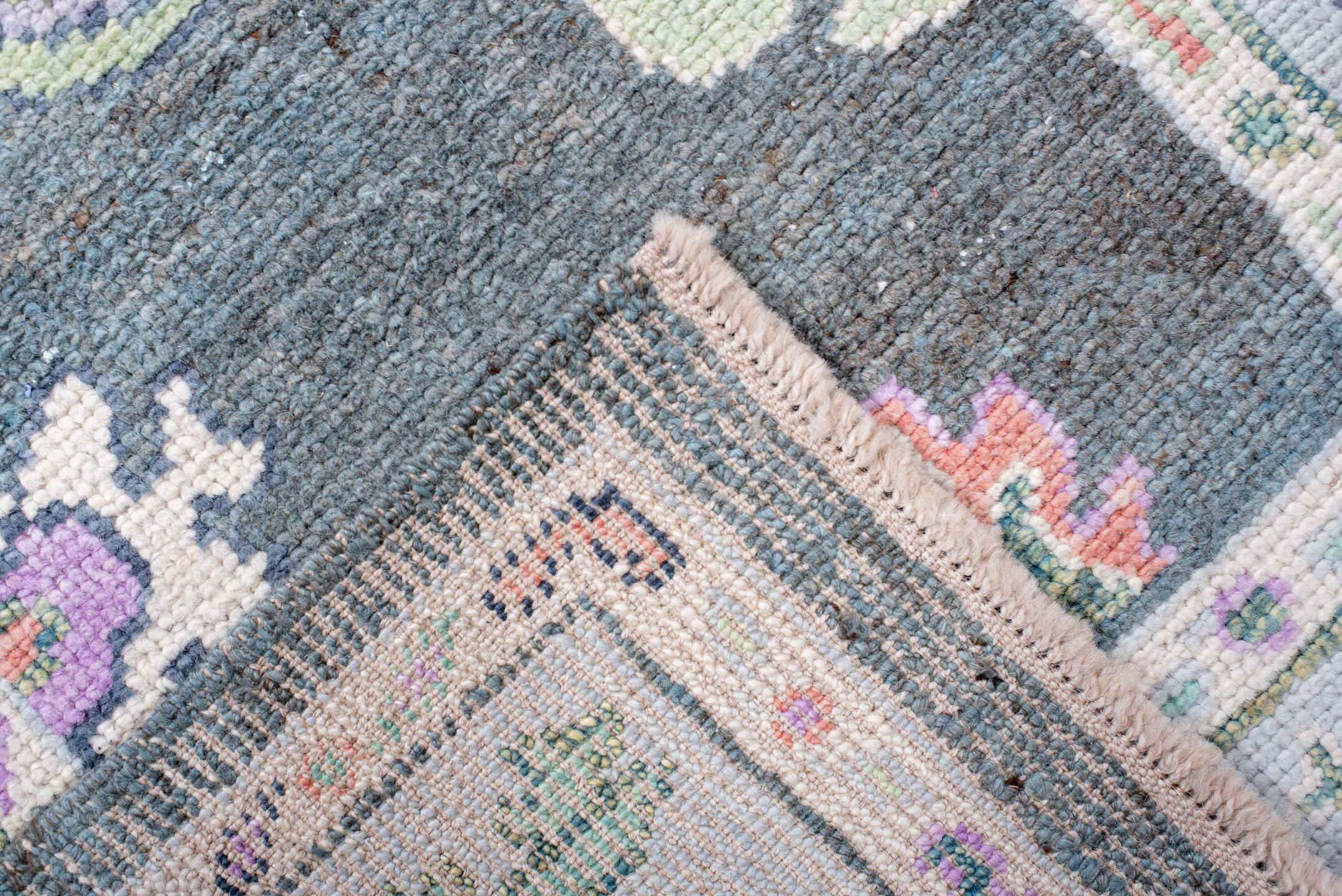 3' x 6' one-of-a-kind handmade vintage Oushak runner rug. Color palette: charcoal, ivory, lavender, sage, soft blue, coral