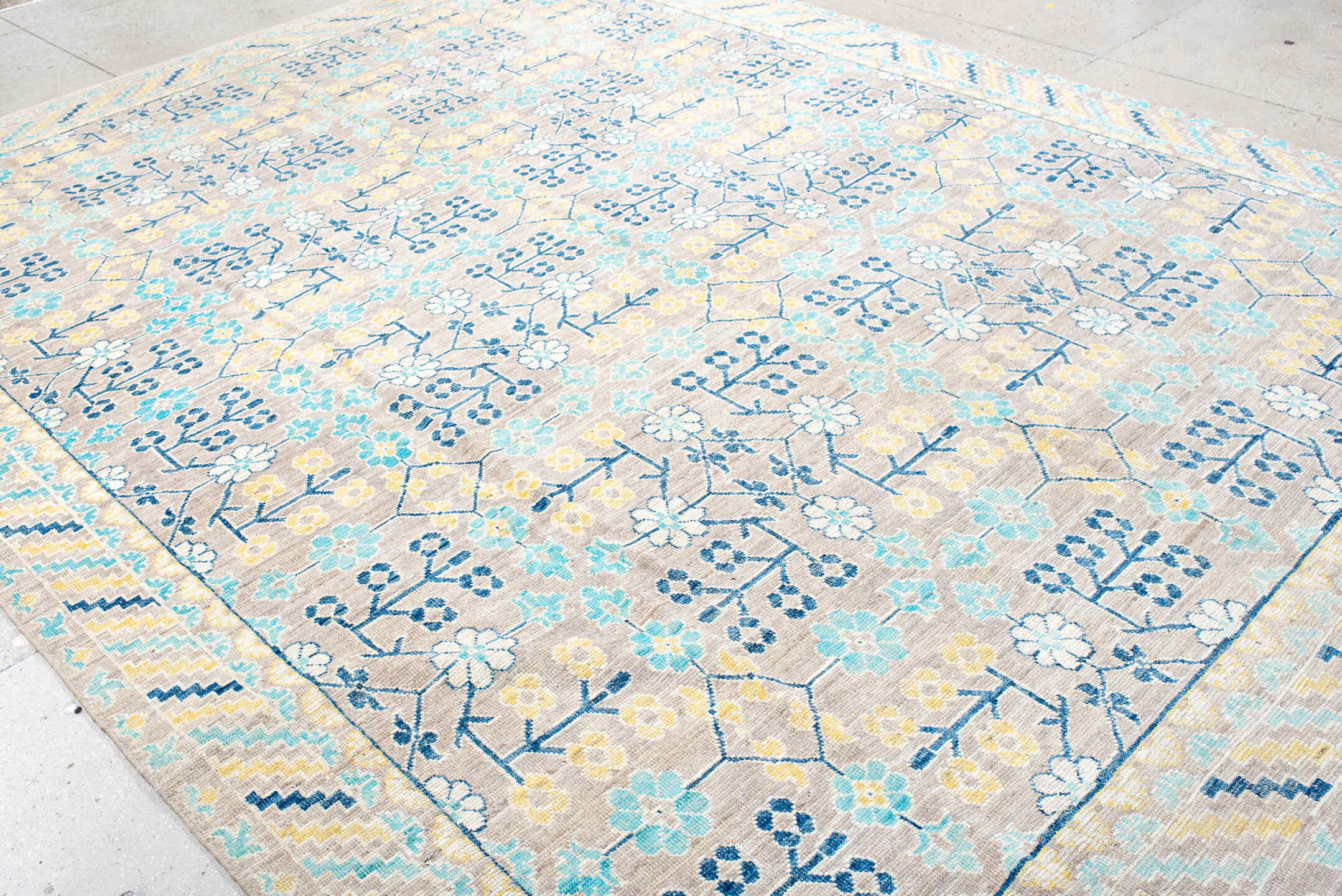 9' x 12' one-of-a-kind handmade vintage Khotan large size rug. Color palette: ivory, sky_blue, navy, pale_gold, taupe, cream