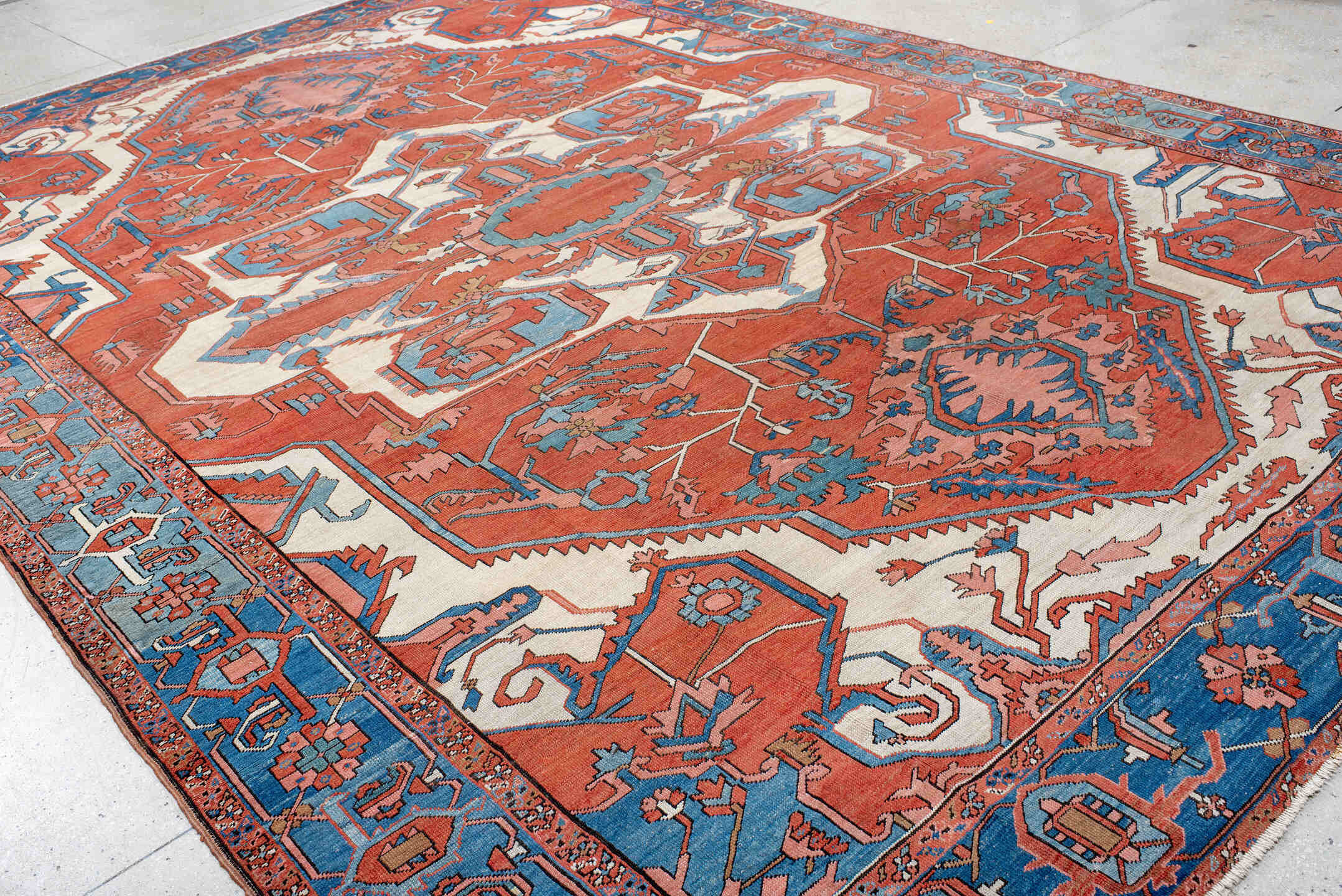 10' x 15' one-of-a-kind handmade vintage Serapi rug. Color palette: terra cotta, sky blue, ivory, rose, rust, camel