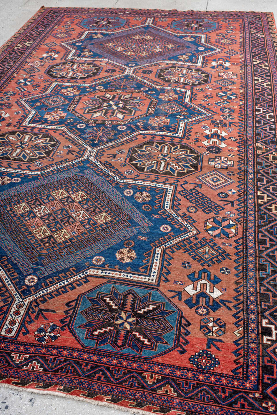 7' x 12' one-of-a-kind handmade vintage Sumak large size rug. Color palette: rust, indigo, navy, ivory, burgundy, teal