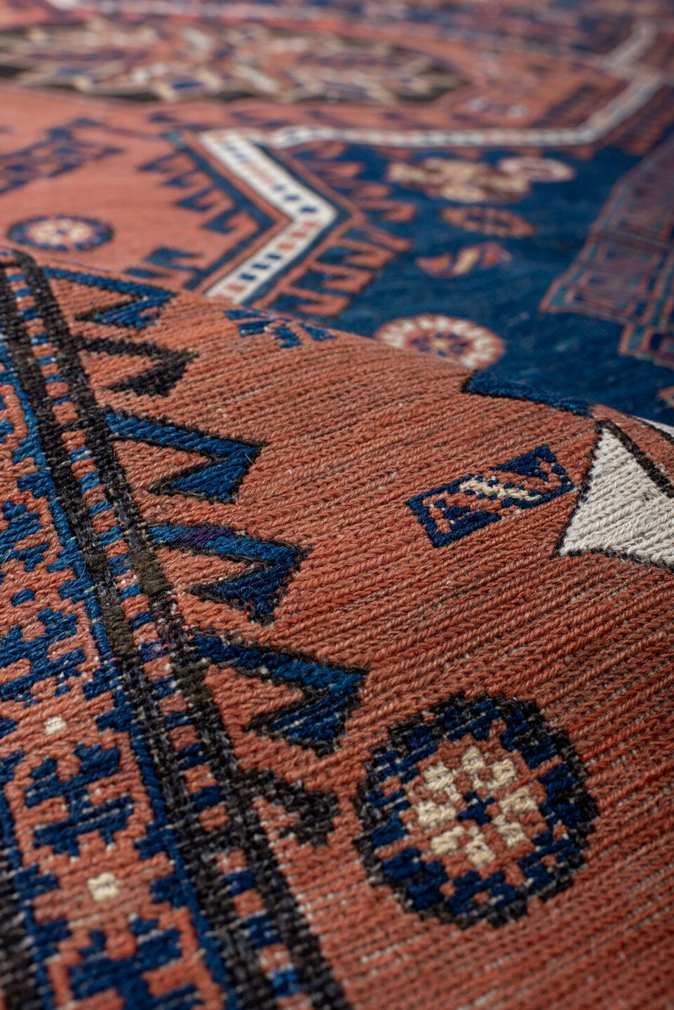 7' x 12' one-of-a-kind handmade vintage Sumak large size rug. Color palette: rust, indigo, navy, ivory, burgundy, teal