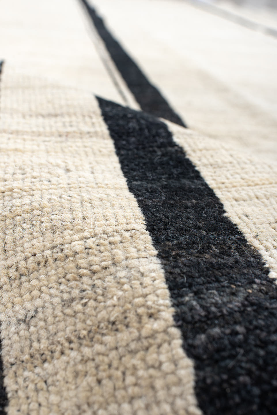 8' x 9' one-of-a-kind handmade vintage Tulu rug. Color palette: ivory, charcoal, ebony, cream, taupe, gray, black, beige