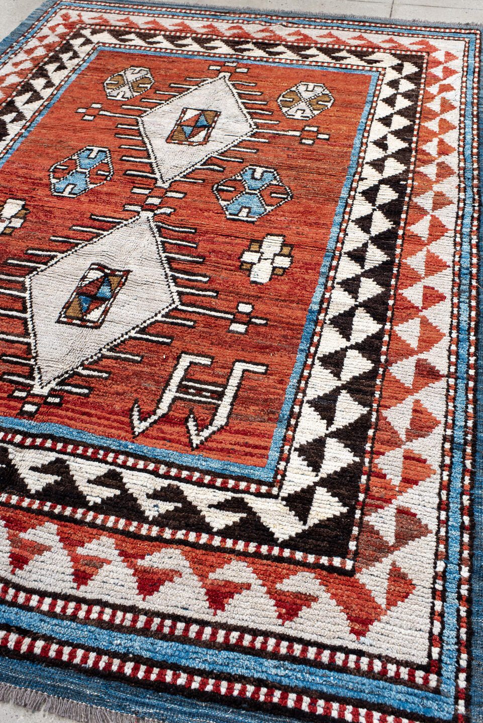 6' x 9' one-of-a-kind handmade vintage Tulu medium size rug. Color palette: rust, ivory, black, blue, brown, terracotta