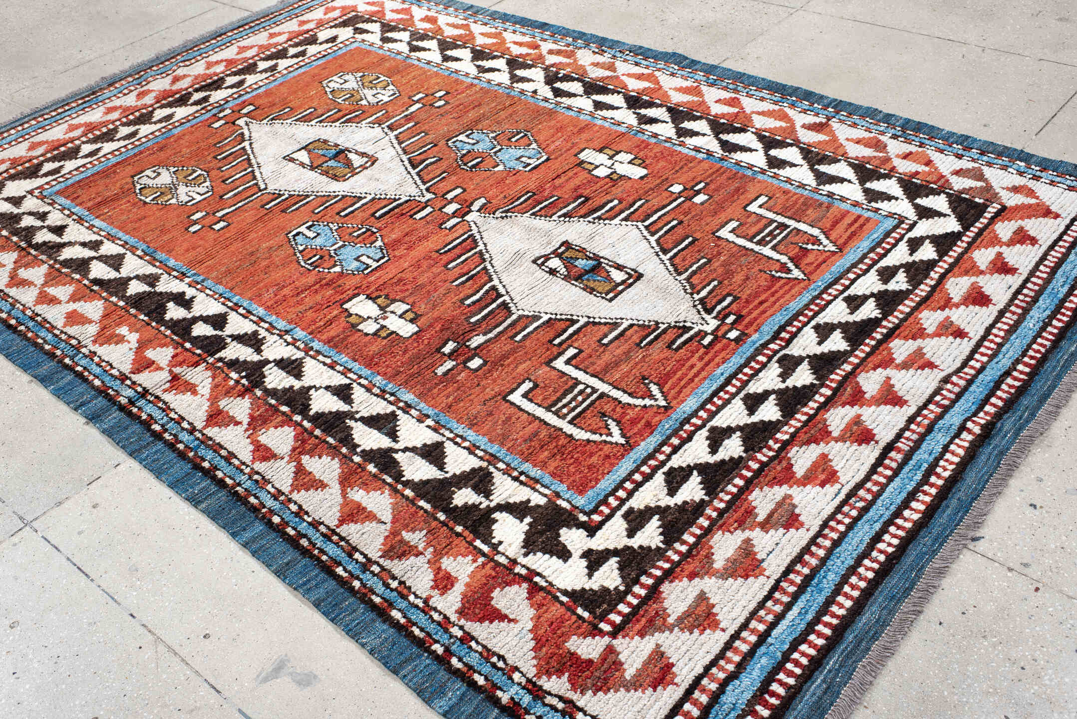 6' x 9' one-of-a-kind handmade vintage Tulu medium size rug. Color palette: rust, ivory, black, blue, brown, terracotta