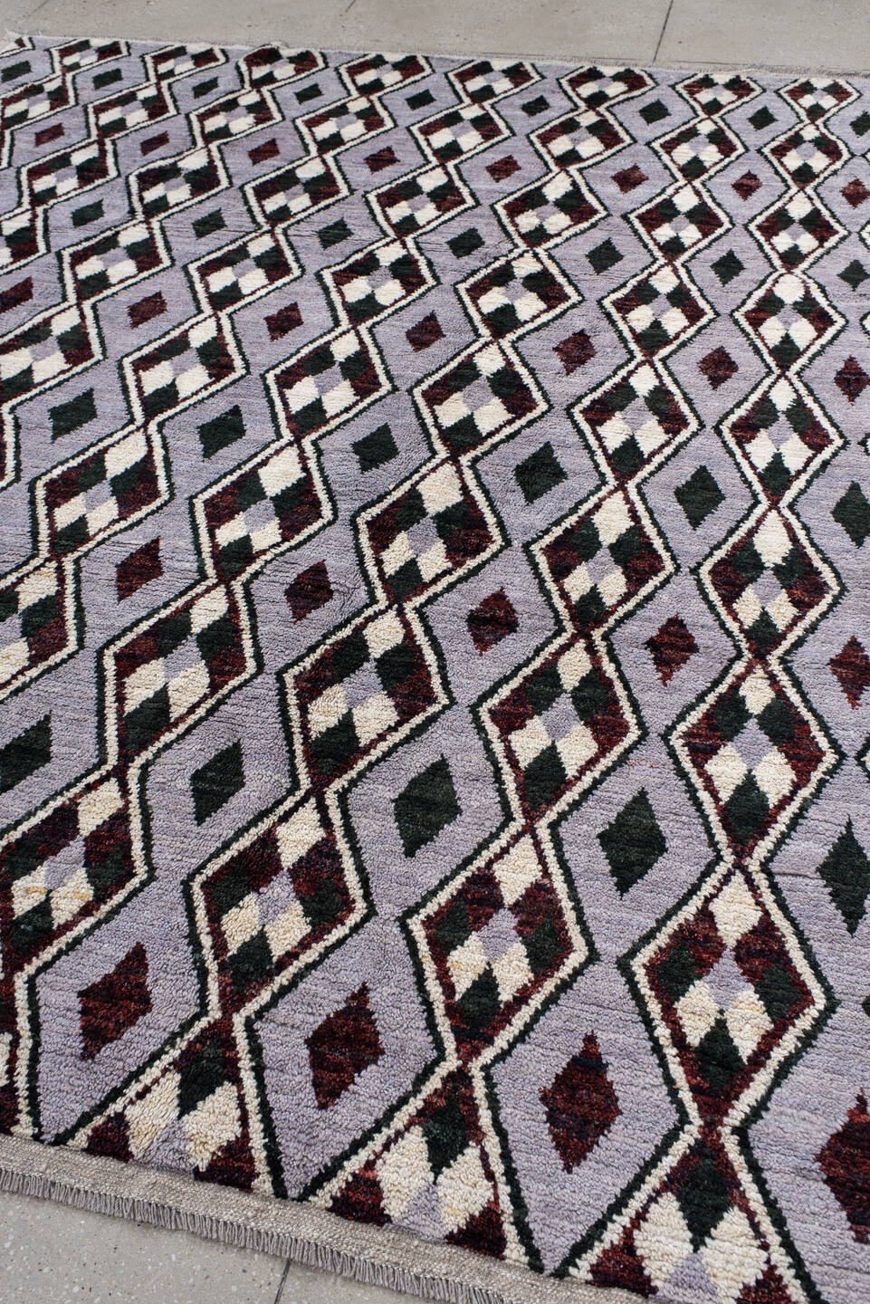 7' x 9' one-of-a-kind handmade vintage Tulu rug. Color palette: lavender, charcoal, ivory, burgundy, light gray, gray, black