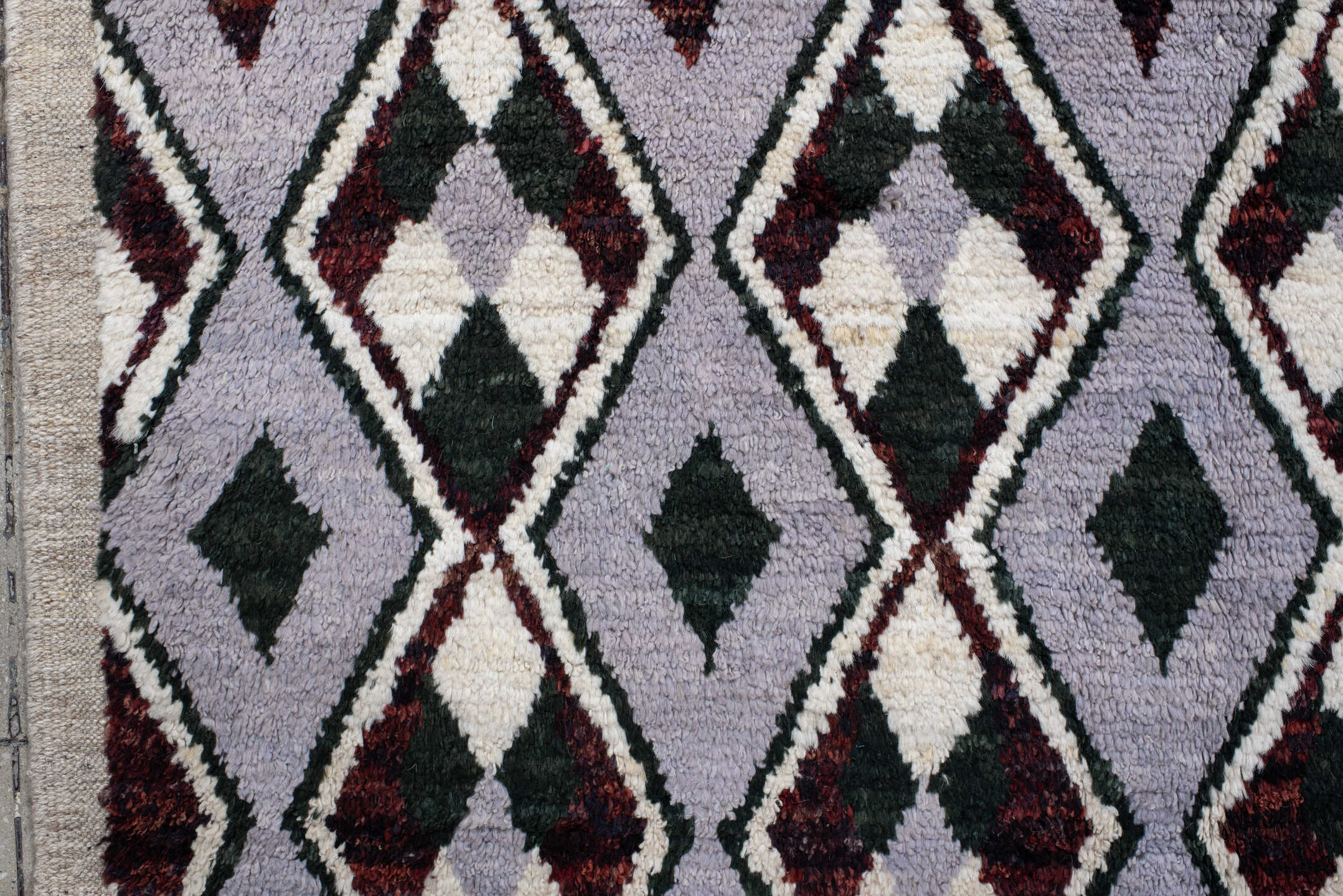 7' x 9' one-of-a-kind handmade vintage Tulu rug. Color palette: lavender, charcoal, ivory, burgundy, light gray, gray, black