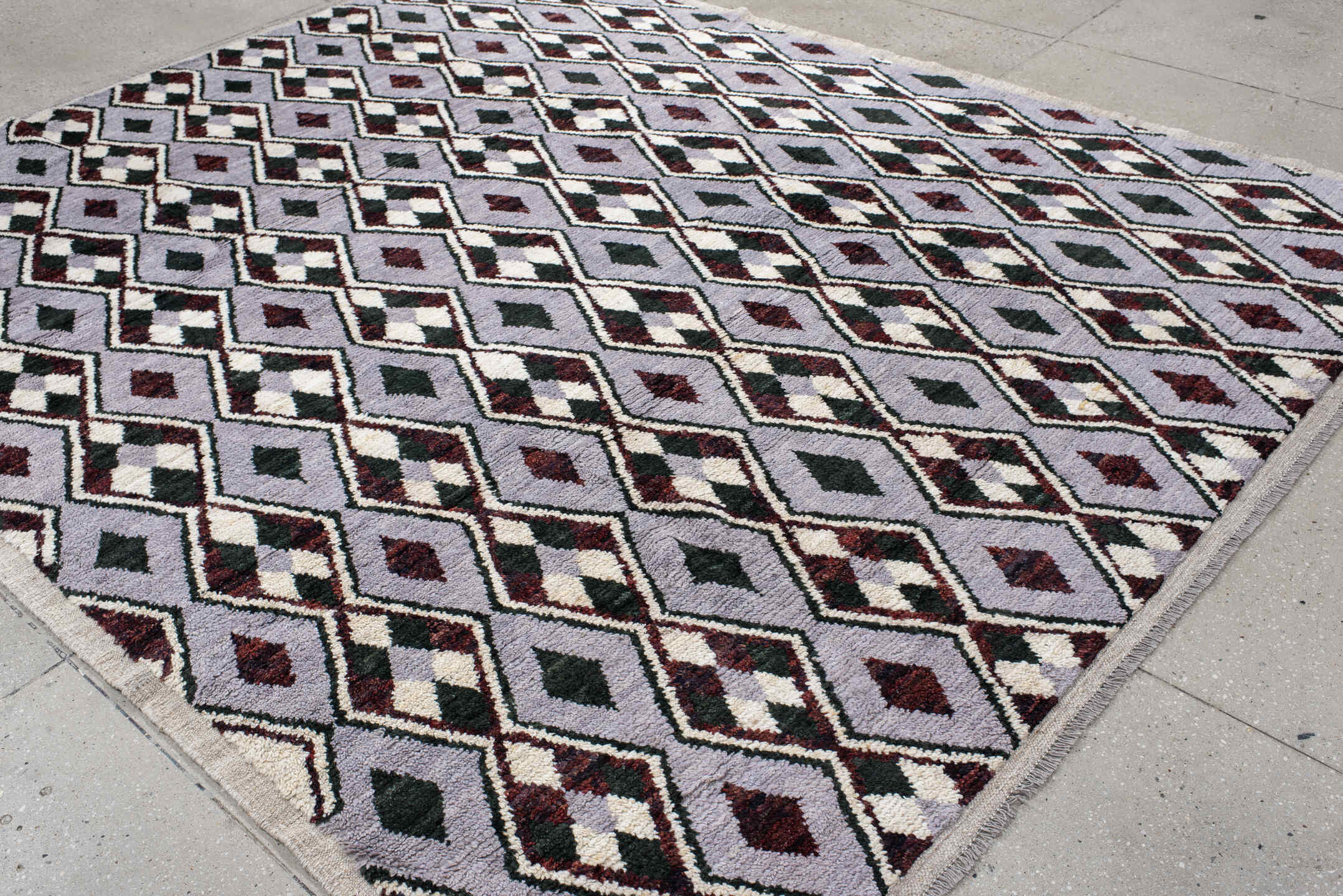 7' x 9' one-of-a-kind handmade vintage Tulu rug. Color palette: lavender, charcoal, ivory, burgundy, light gray, gray, black