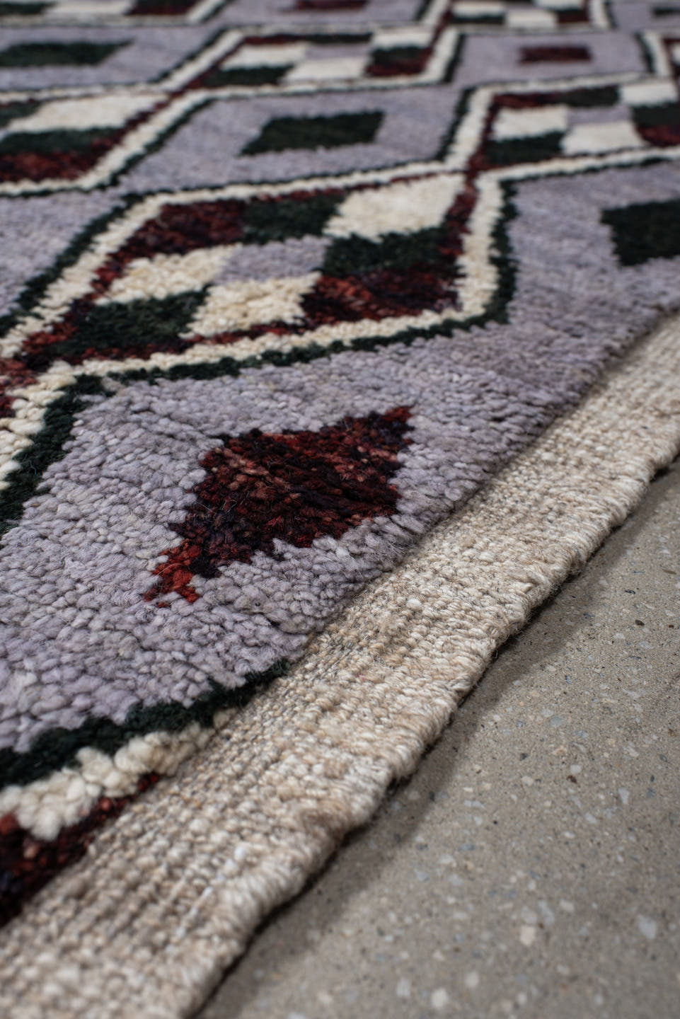 7' x 9' one-of-a-kind handmade vintage Tulu rug. Color palette: lavender, charcoal, ivory, burgundy, light gray, gray, black