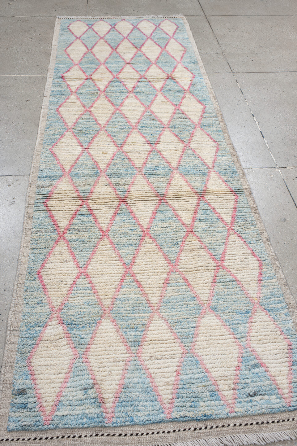 3' x 9' one-of-a-kind handmade vintage Tulu runner rug. Color palette: ivory, sky blue, pink, taupe, light blue, beige, gray