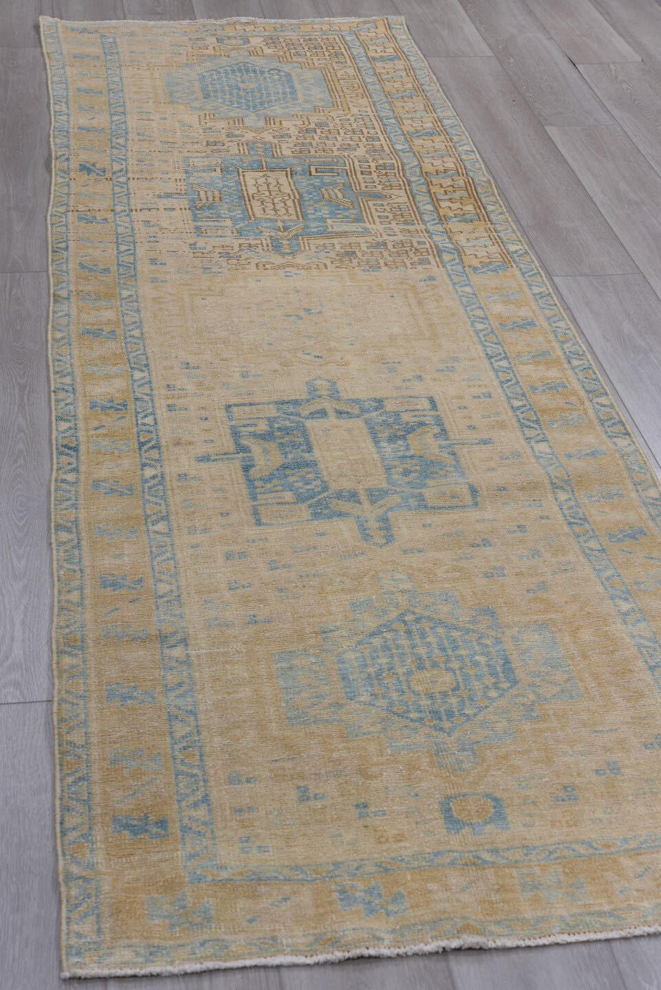 3' x 10' one-of-a-kind handmade antique Heriz runner rug. Color palette: ivory, sky blue, beige, taupe, camel, light blue