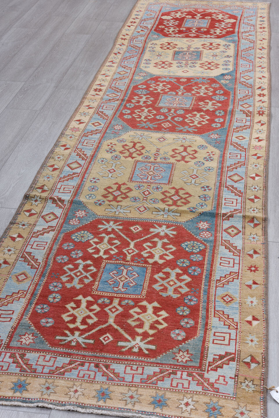 3' x 13' one-of-a-kind handmade antique Caucasian runner rug. Color palette: red, ivory, sky blue, camel, rust, navy