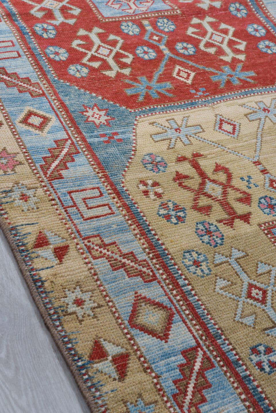 3' x 13' one-of-a-kind handmade antique Caucasian runner rug. Color palette: red, ivory, sky blue, camel, rust, navy