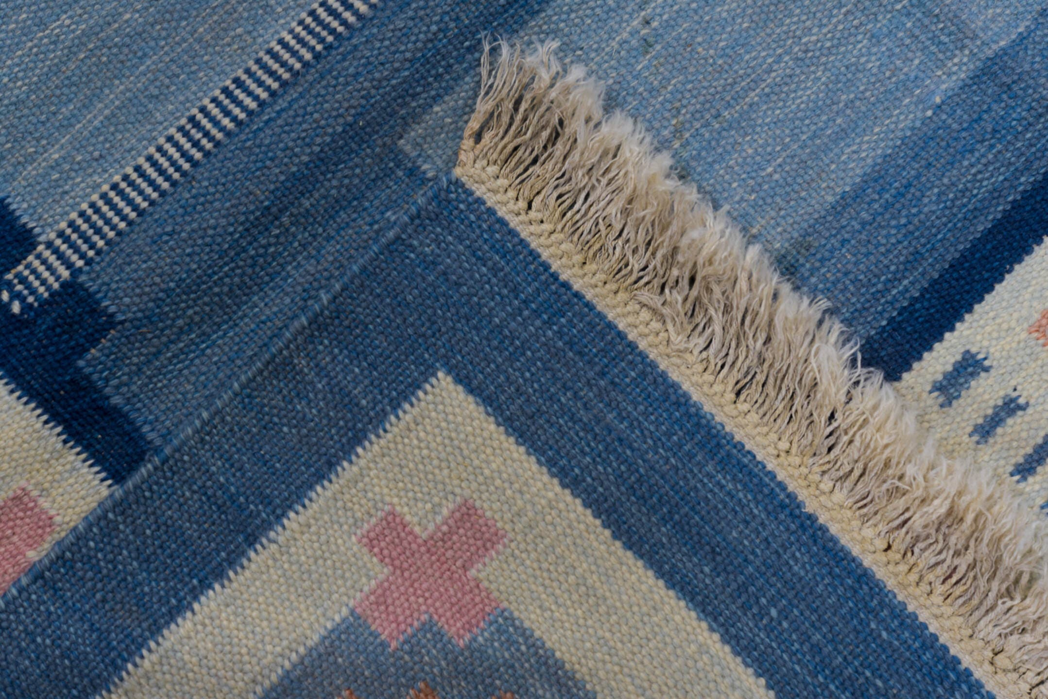 5' x 7' one-of-a-kind handmade antique Rollaken rug. Color palette: blue, ivory, navy, peach, pink, beige, terracotta