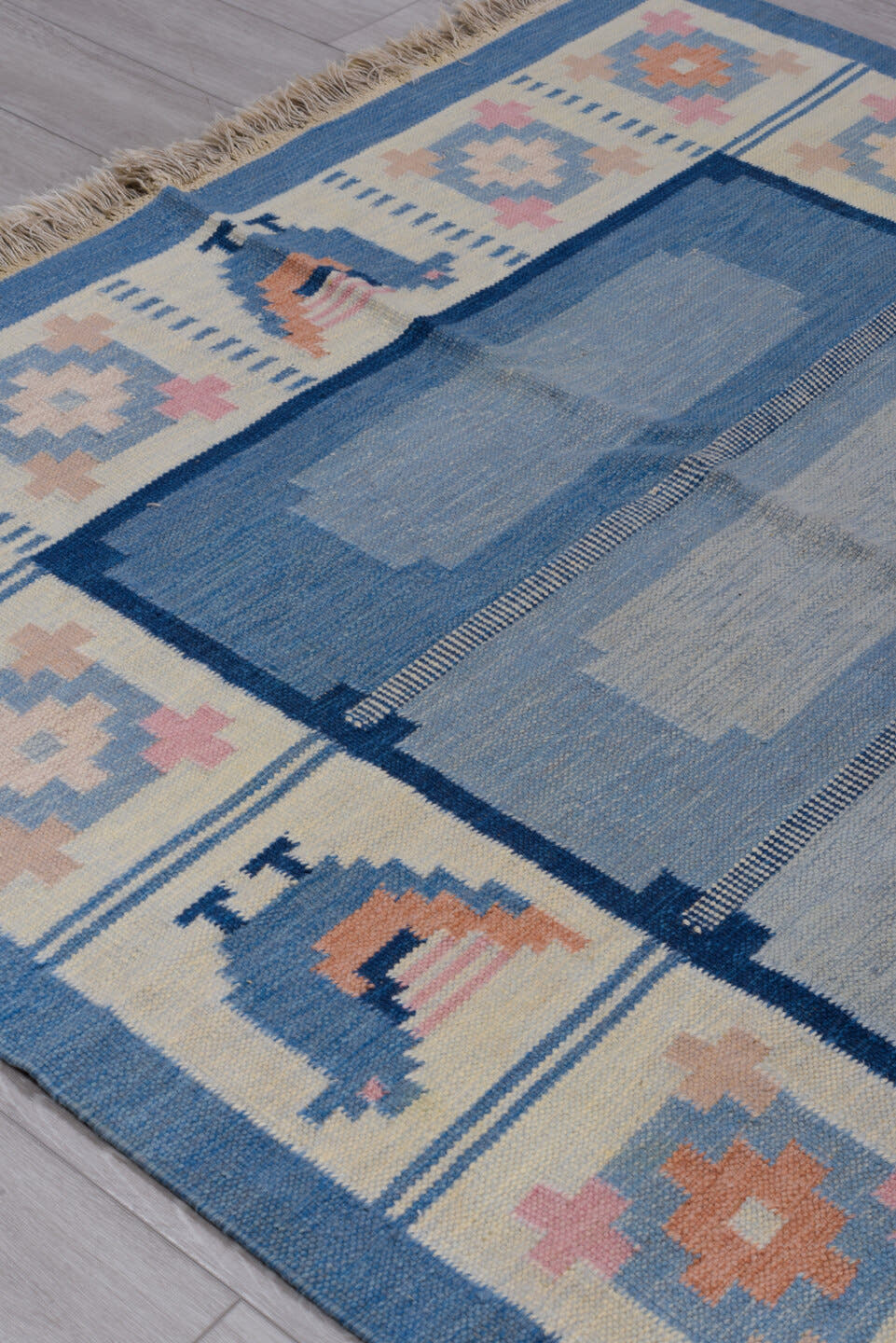 5' x 7' one-of-a-kind handmade antique Rollaken rug. Color palette: blue, ivory, navy, peach, pink, beige, terracotta