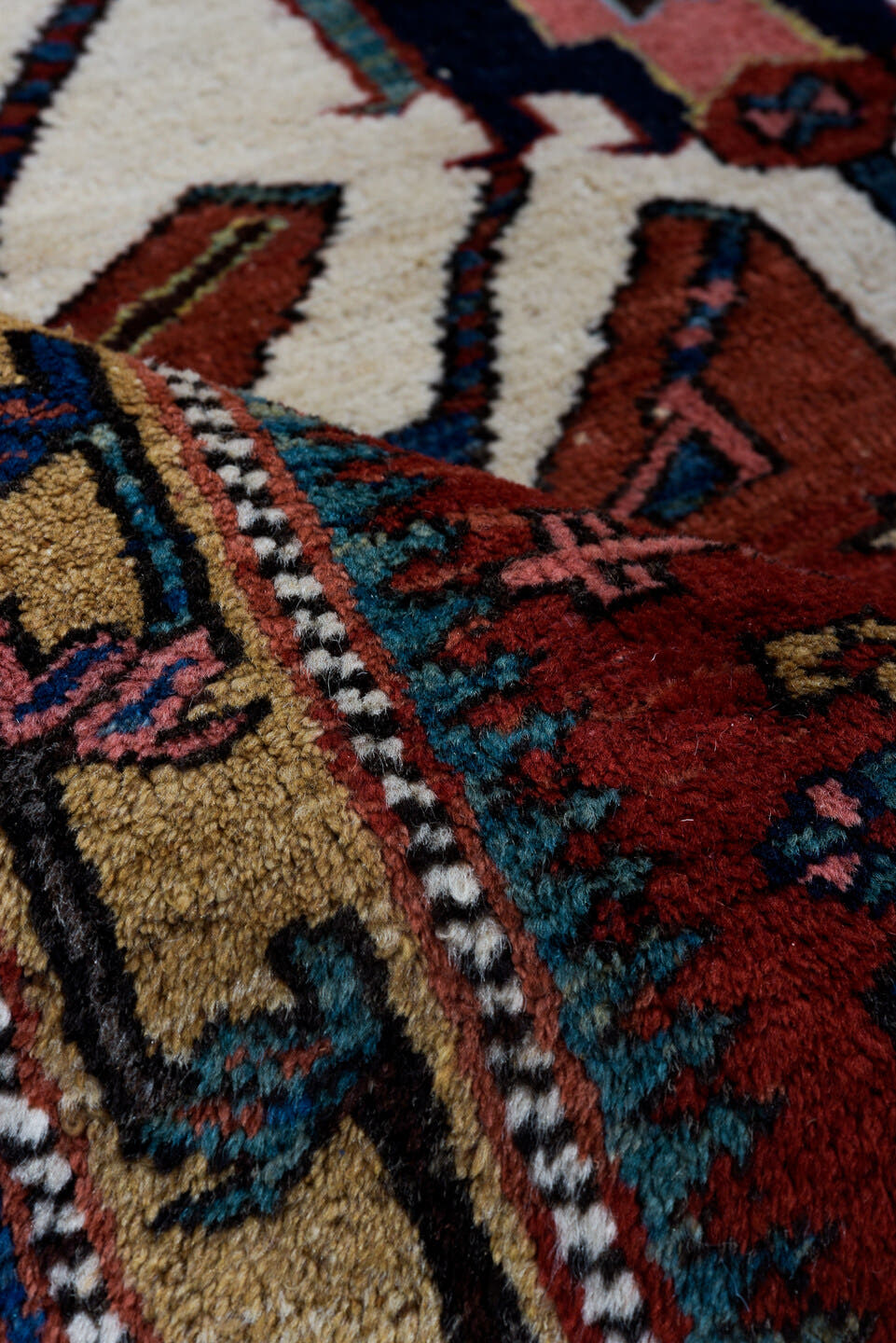 4' x 7' one-of-a-kind handmade antique Karaje rug. Color palette: rust, ivory, blue, navy, crimson, charcoal, camel, teal