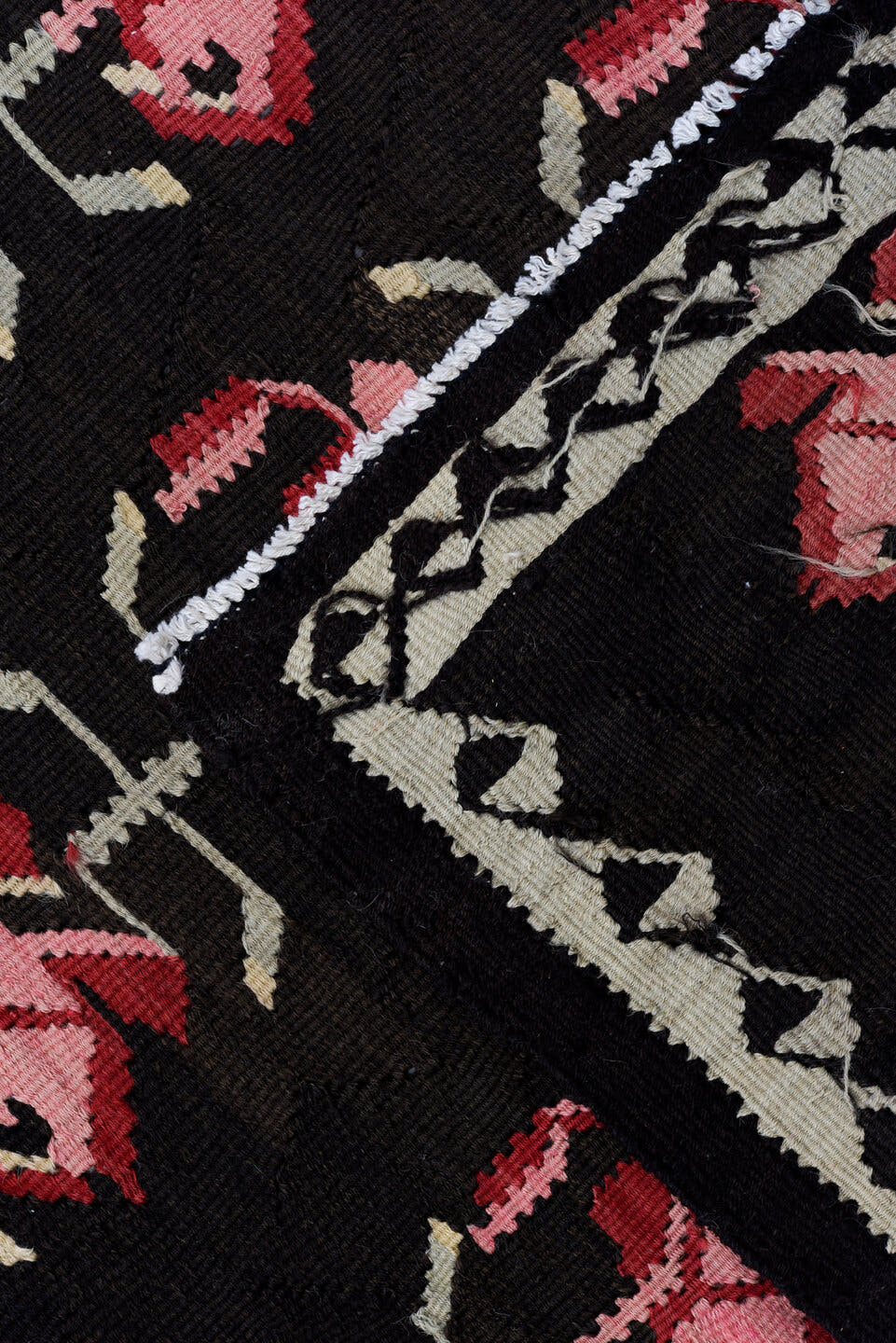 5' x 11' one-of-a-kind handmade antique Besserabian rug. Color palette: charcoal, taupe, crimson, rose, ivory, black, gray