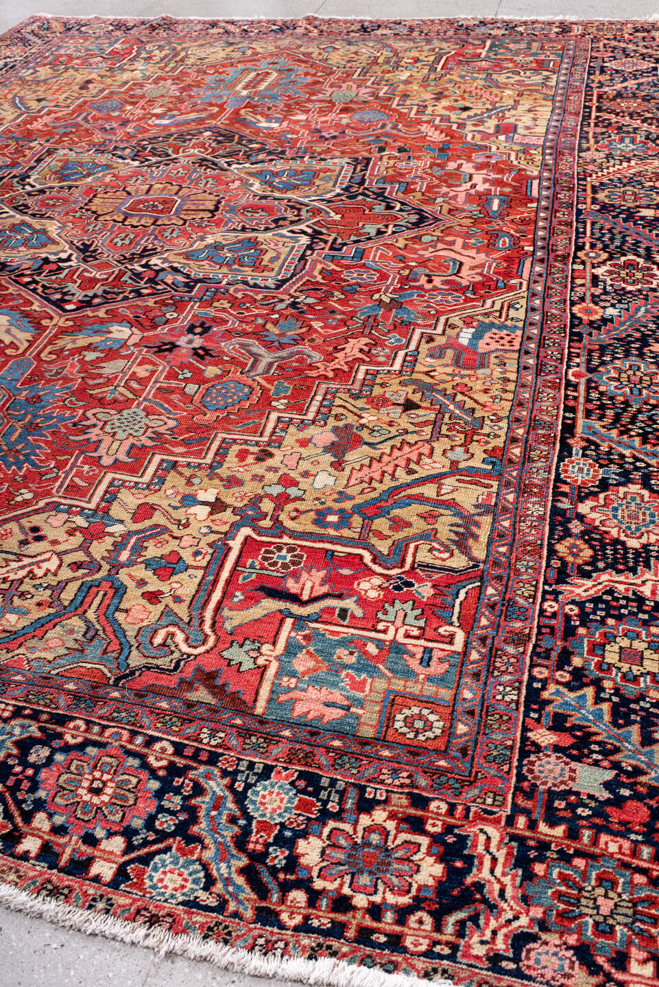 11' x 14' one-of-a-kind handmade vintage Heriz oversize rug. Color palette: red, navy, ivory, sky blue, coral, camel, pink