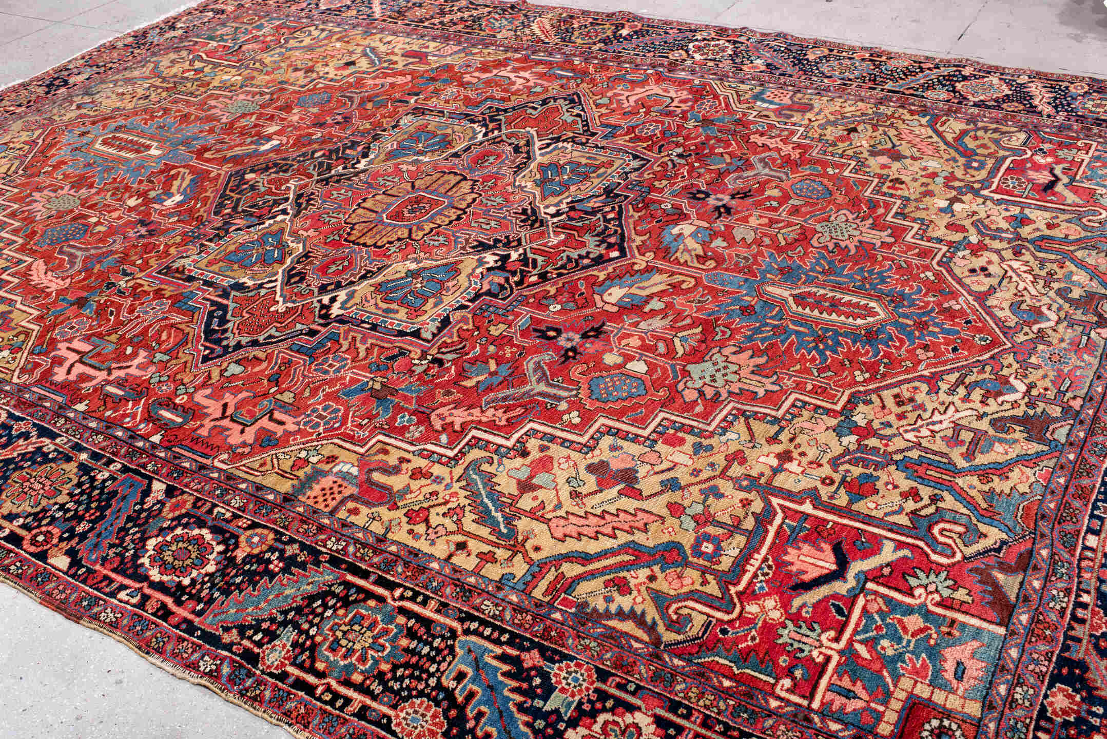 11' x 14' one-of-a-kind handmade vintage Heriz oversize rug. Color palette: red, navy, ivory, sky blue, coral, camel, pink