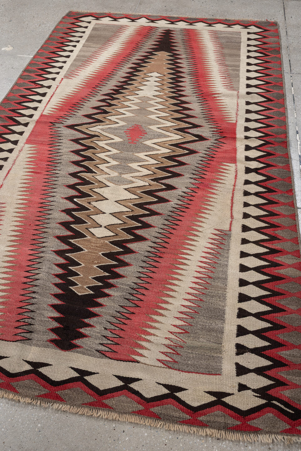 4' x 7' one-of-a-kind handmade vintage Navajo rug. Color palette: ivory, rust, taupe, charcoal, black, camel, terracotta