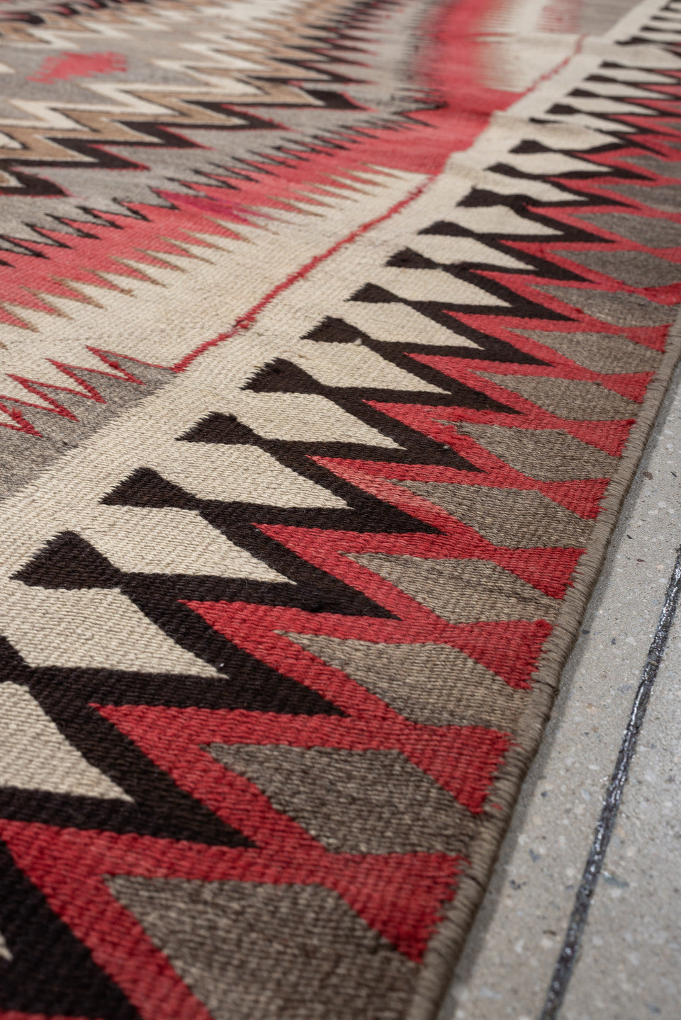 4' x 7' one-of-a-kind handmade vintage Navajo rug. Color palette: ivory, rust, taupe, charcoal, black, camel, terracotta