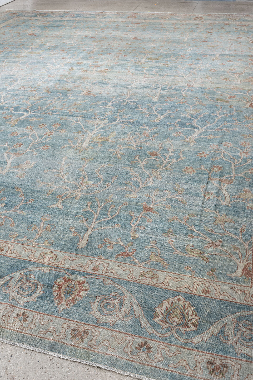 15' x 17' one-of-a-kind handmade antique Laristan oversize rug. Color palette: pale blue, ivory, blush, sage, taupe