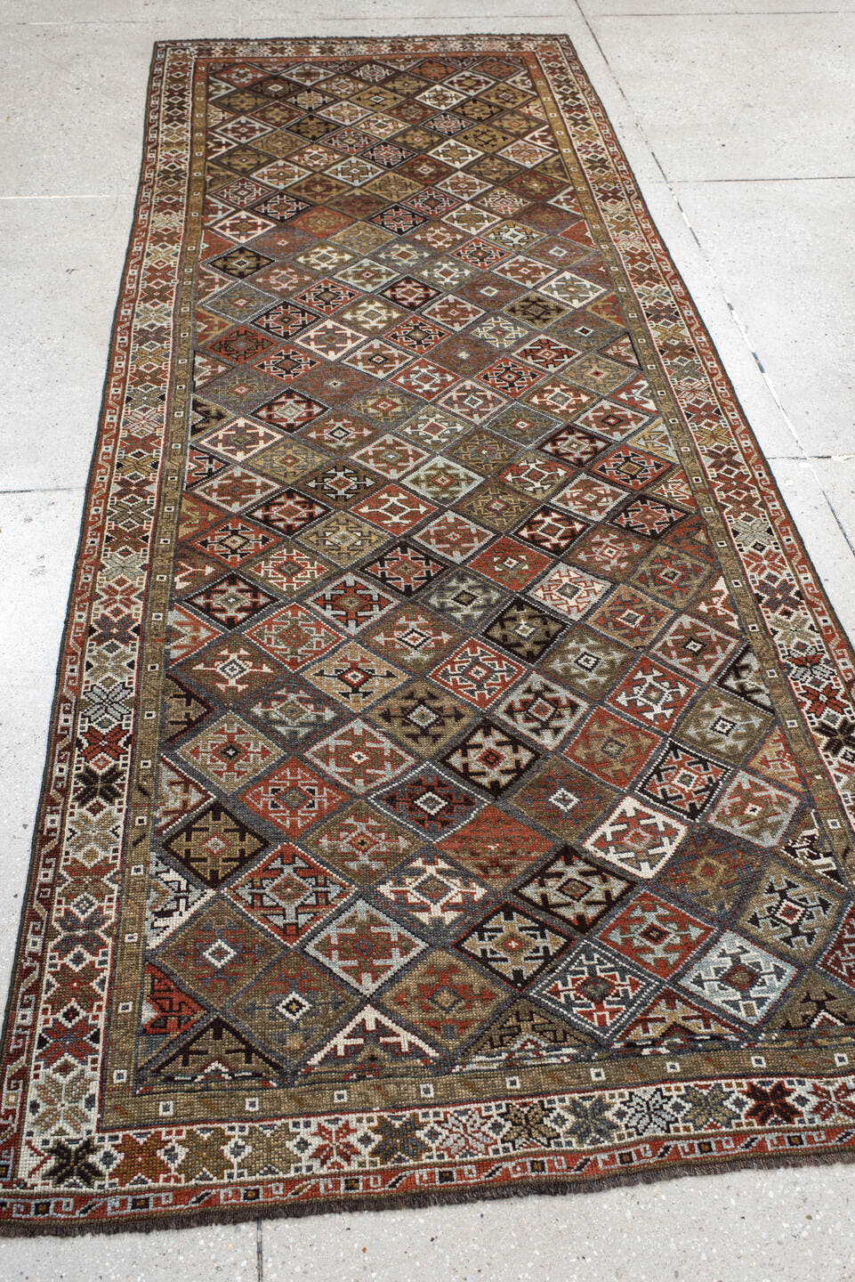 3' x 9' one-of-a-kind handmade antique Kurd runner rug. Color palette: taupe, rust, ivory, brown, charcoal, camel, burgundy