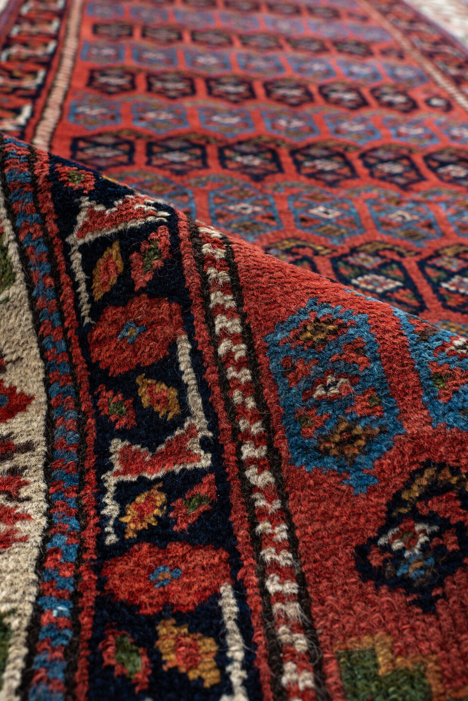 2' x 12' one-of-a-kind handmade vintage NW Persian runner rug. Color palette: black, blue, brown, gray, pink, red, redwood