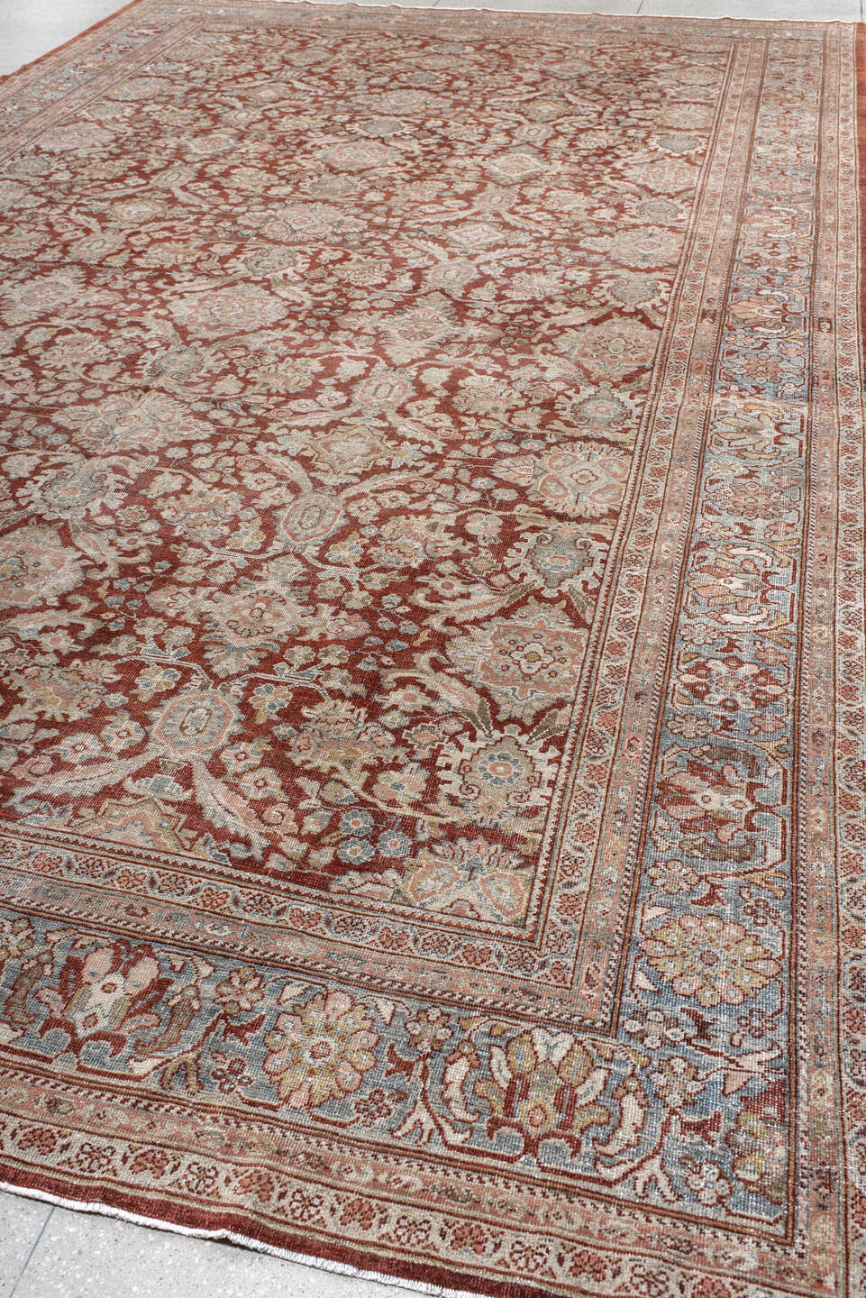 10' x 18' one-of-a-kind handmade antique Sultanabad rug. Color palette: rust, ivory, light blue, taupe, camel, brown