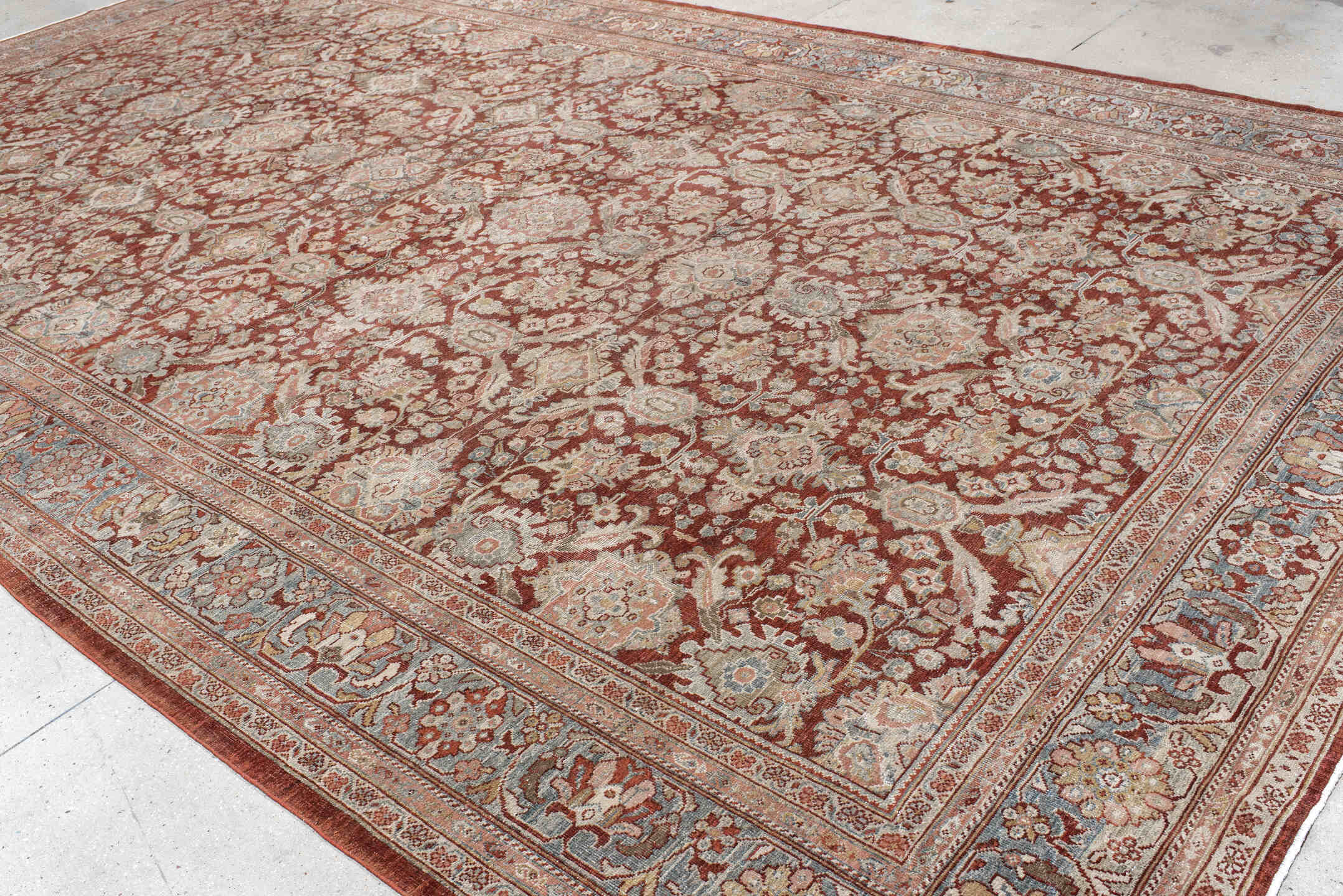 10' x 18' one-of-a-kind handmade antique Sultanabad rug. Color palette: rust, ivory, light blue, taupe, camel, brown