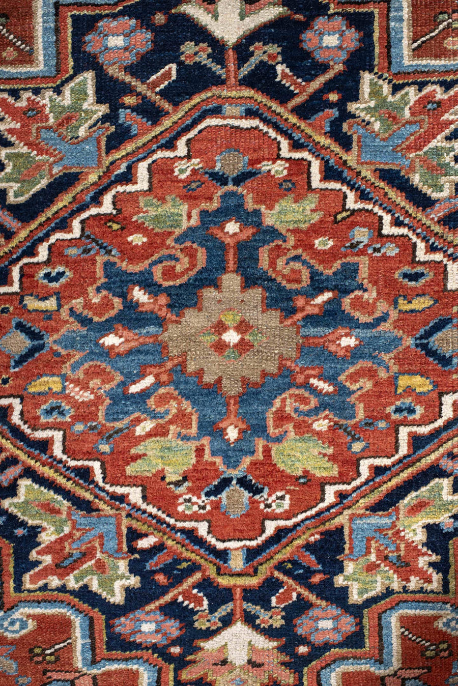 7' x 11' one-of-a-kind handmade antique Heriz large size rug. Color palette: rust, navy, ivory, sky blue, terra cotta, camel