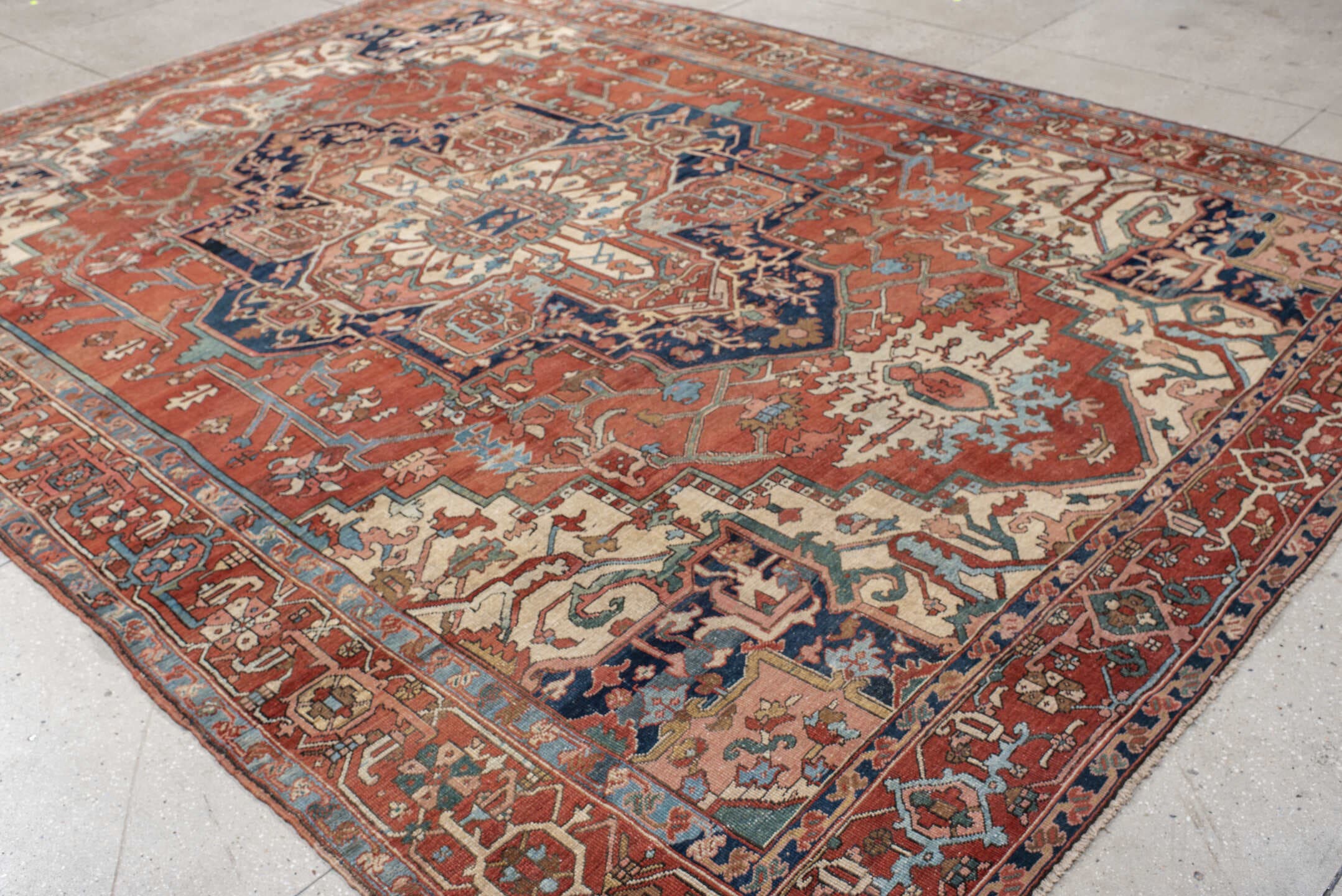 9' x 12' one-of-a-kind handmade vintage Serapi large size rug. Color palette: terra cotta, ivory, sky blue, navy, rust