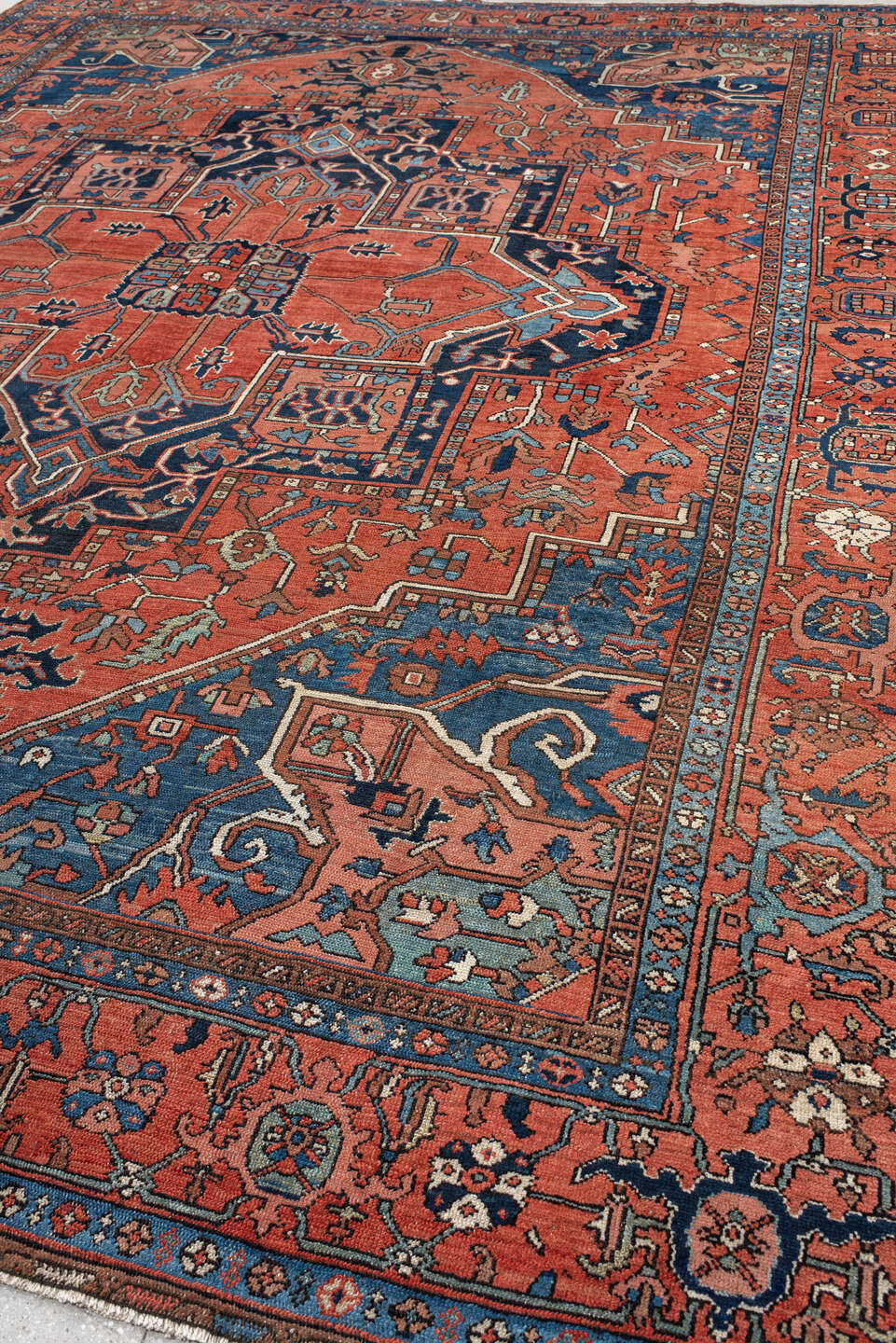 10' x 13' one-of-a-kind handmade antique Serapi large size rug. Color palette: terra cotta, navy, ivory, rust, sky blue