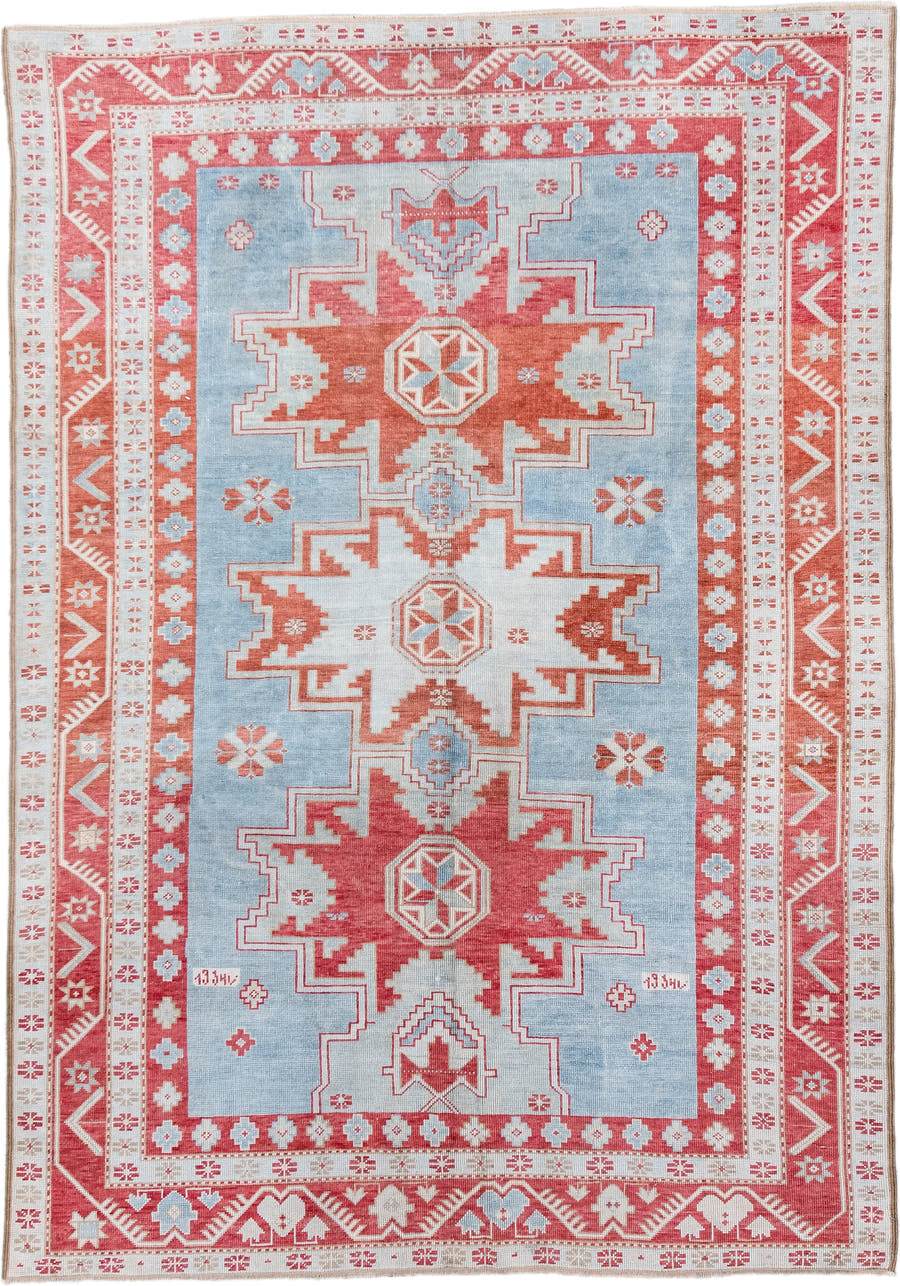 5' x 7' one-of-a-kind handmade antique Caucasian rug. Color palette: sky blue, coral, ivory, brick red, pale blue
