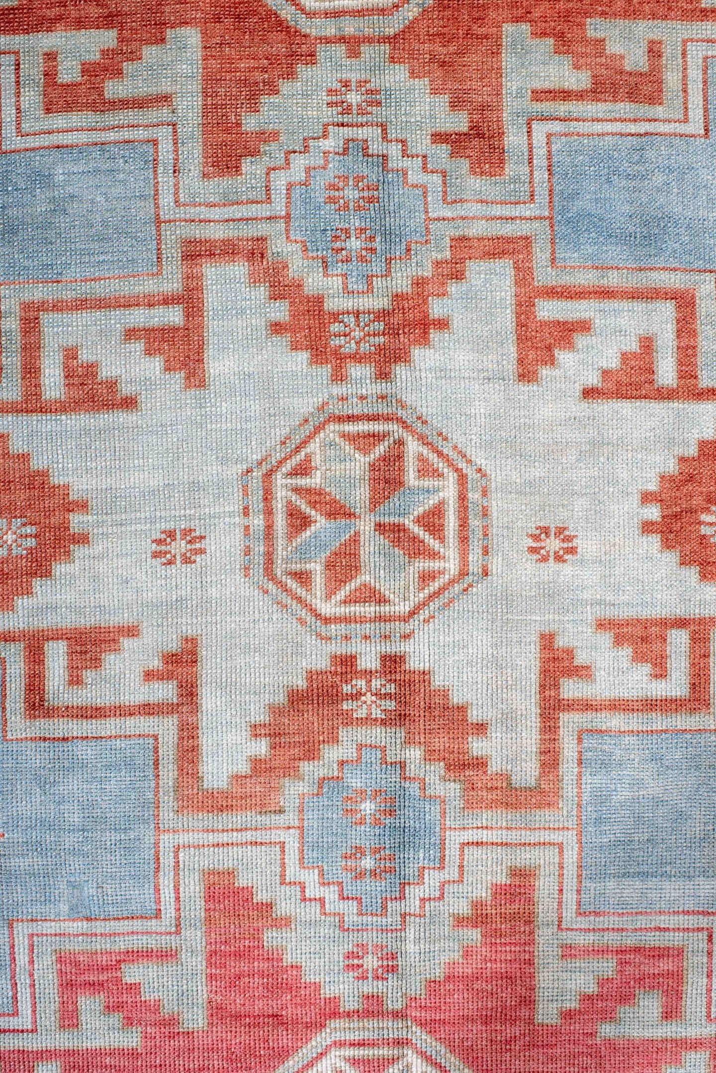 5' x 7' one-of-a-kind handmade antique Caucasian rug. Color palette: sky blue, coral, ivory, brick red, pale blue