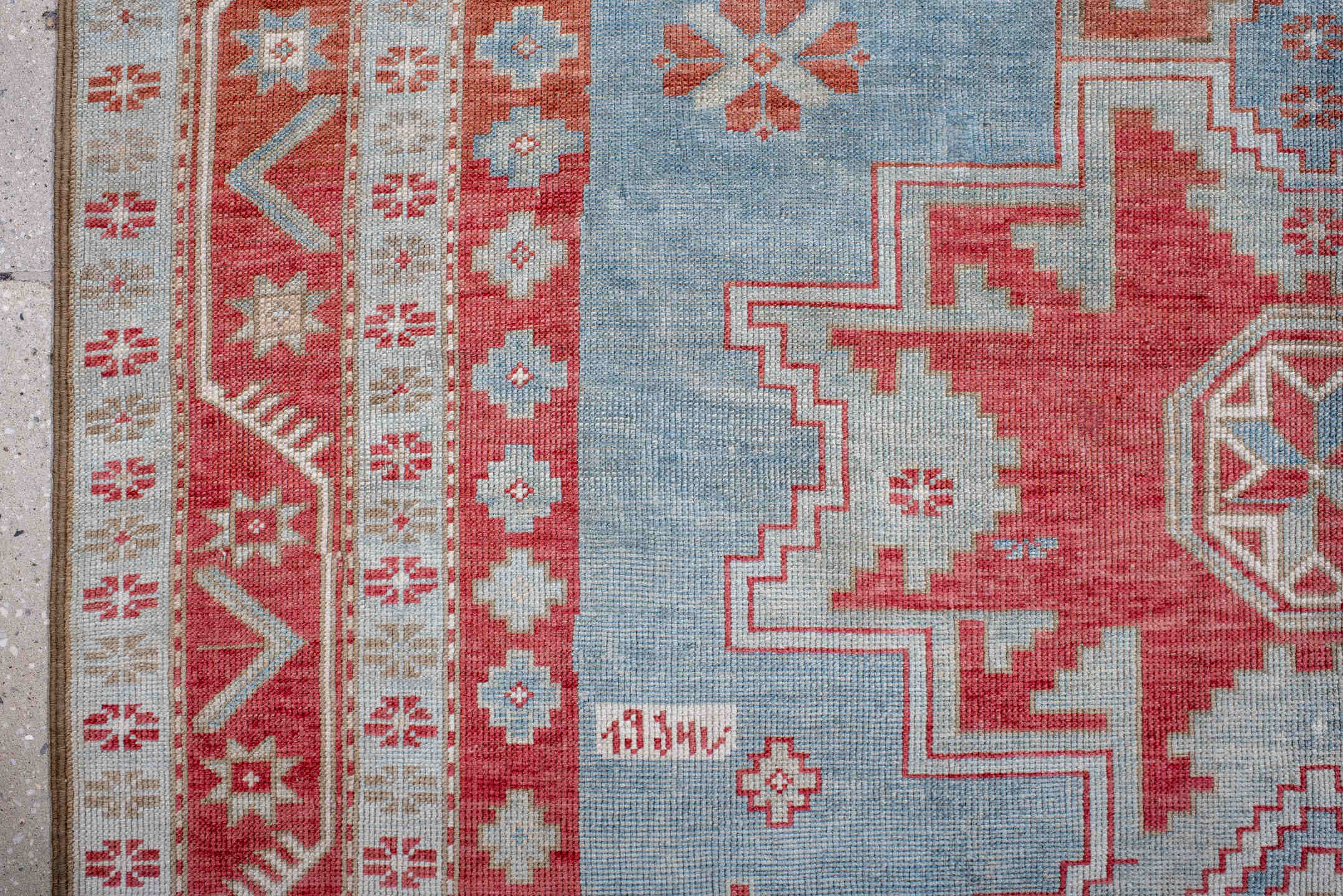 5' x 7' one-of-a-kind handmade antique Caucasian rug. Color palette: sky blue, coral, ivory, brick red, pale blue