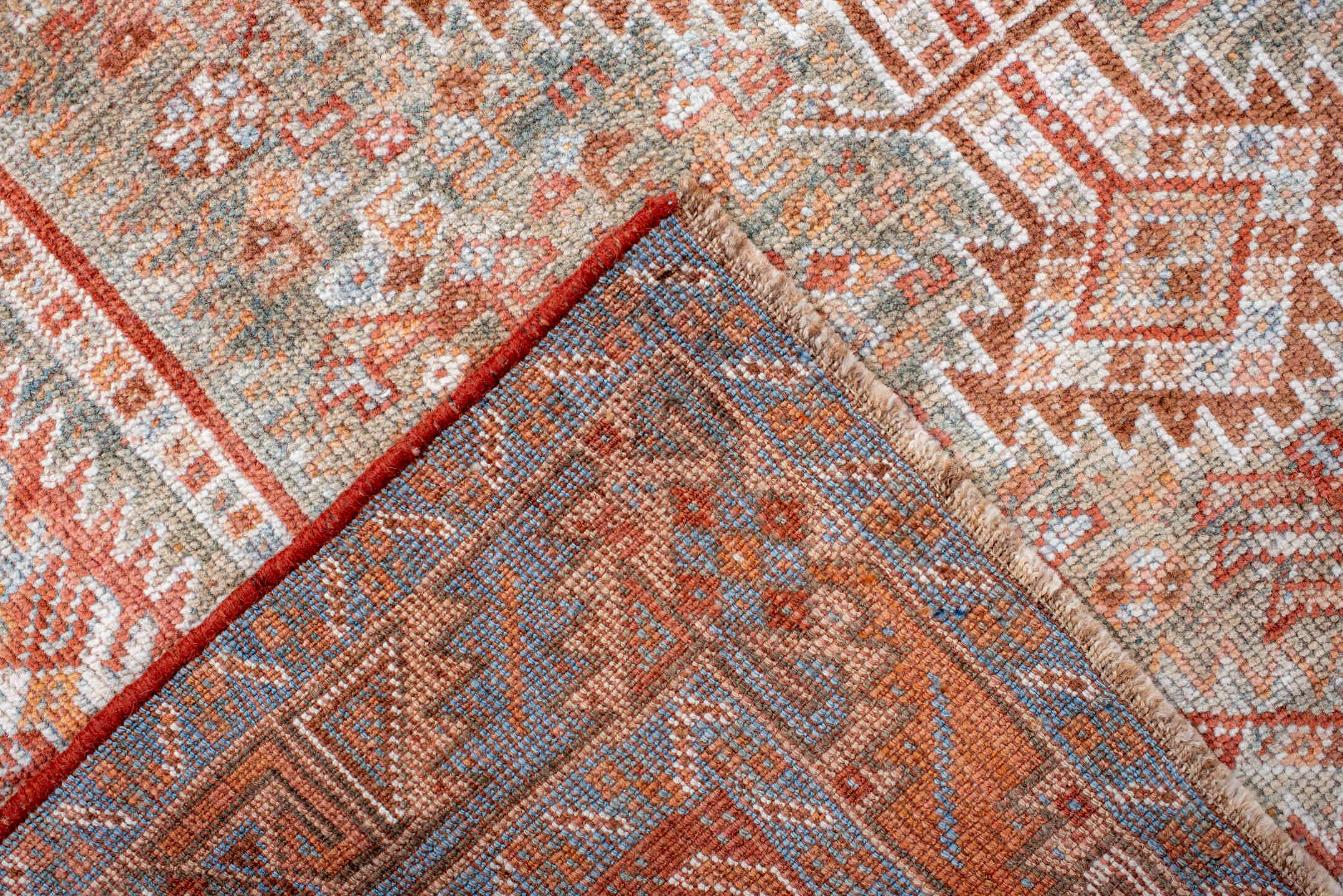 4' x 8' one-of-a-kind handmade antique Shiraz rug. Color palette: rust, ivory, pale blue, terra cotta, camel, taupe, brown