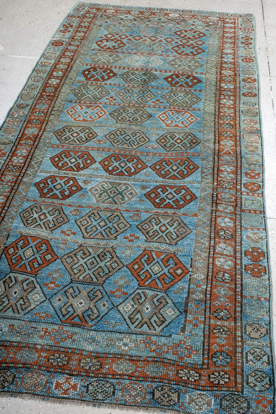 4' x 8' one-of-a-kind handmade antique Kurd runner rug. Color palette: sky blue, rust, taupe, ivory, slate, camel
