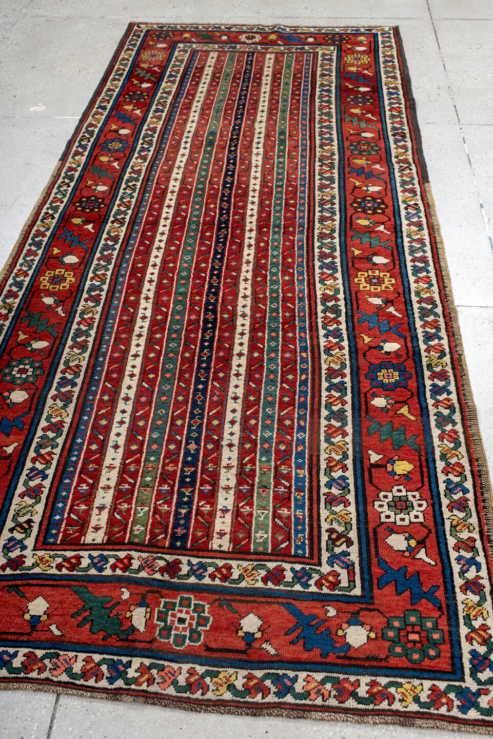 4' x 9' one-of-a-kind handmade antique Caucasian runner rug. Color palette: red, ivory, blue, teal, gold, navy, rust