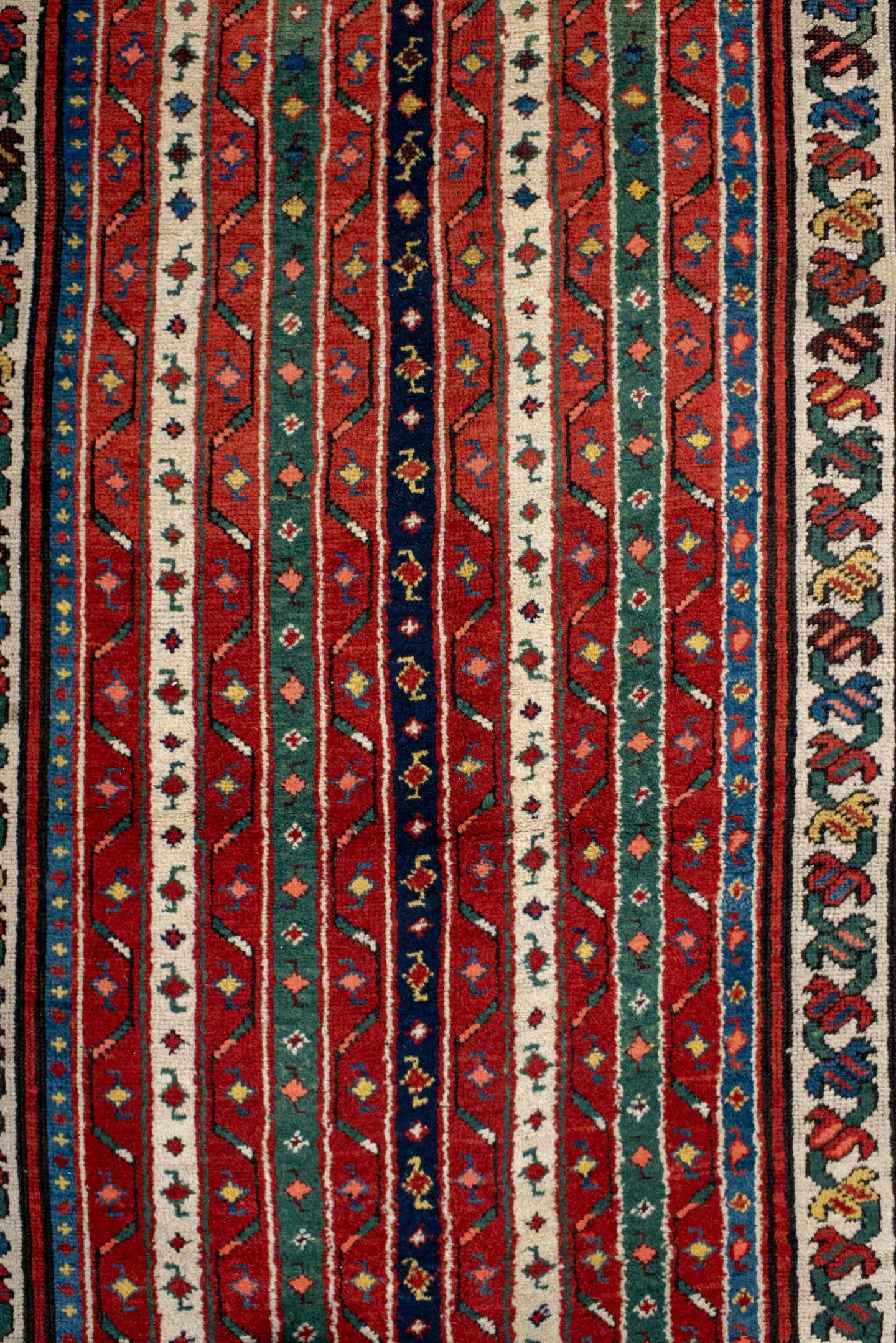 4' x 9' one-of-a-kind handmade antique Caucasian runner rug. Color palette: red, ivory, blue, teal, gold, navy, rust