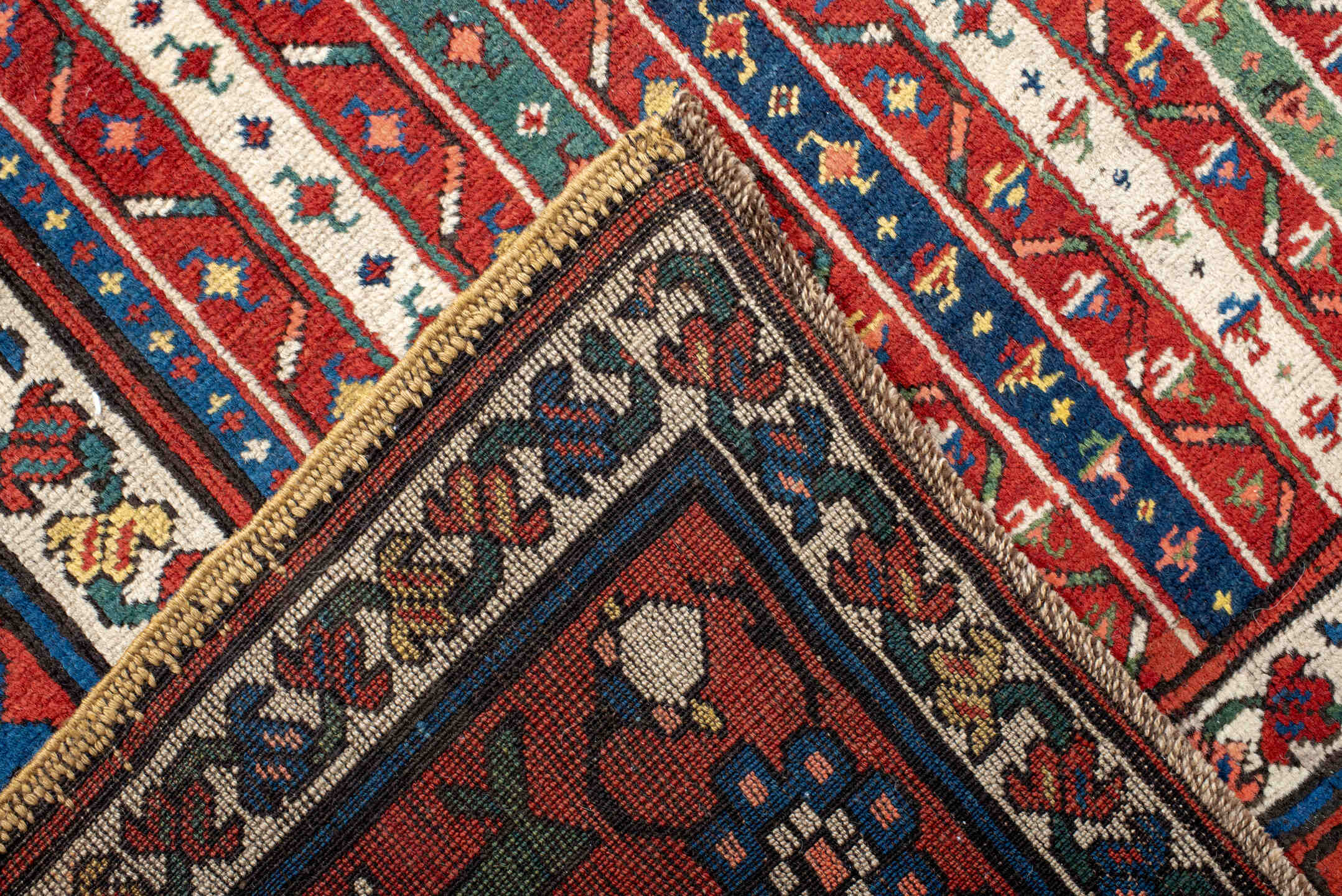 4' x 9' one-of-a-kind handmade antique Caucasian runner rug. Color palette: red, ivory, blue, teal, gold, navy, rust