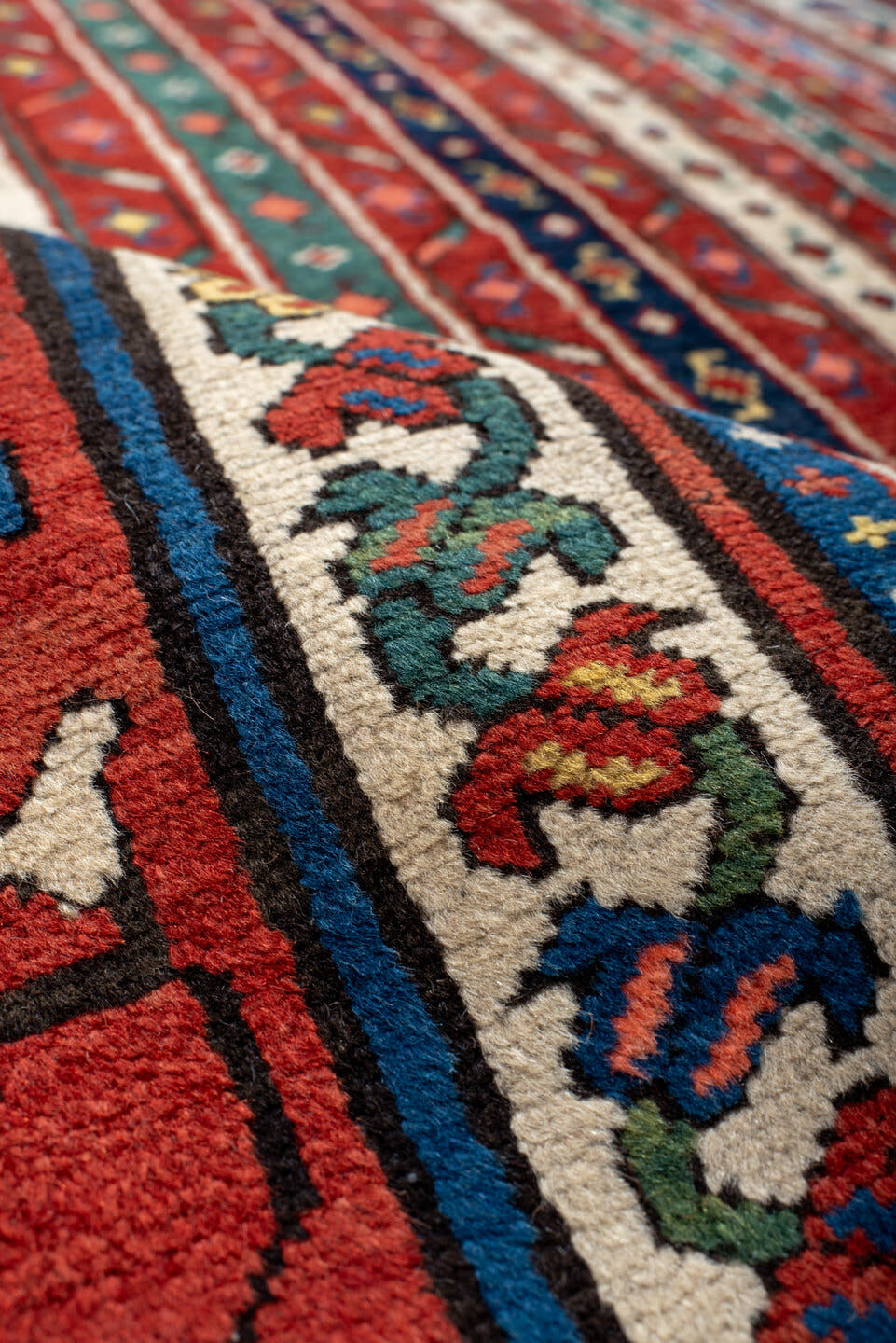 4' x 9' one-of-a-kind handmade antique Caucasian runner rug. Color palette: red, ivory, blue, teal, gold, navy, rust