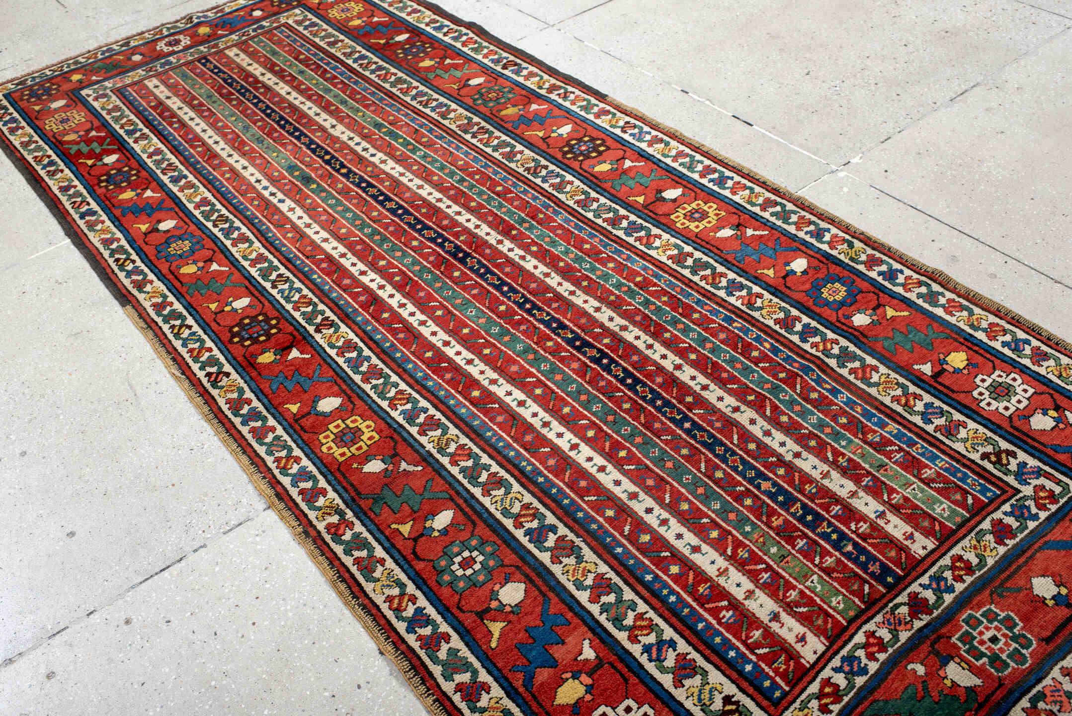 4' x 9' one-of-a-kind handmade antique Caucasian runner rug. Color palette: red, ivory, blue, teal, gold, navy, rust