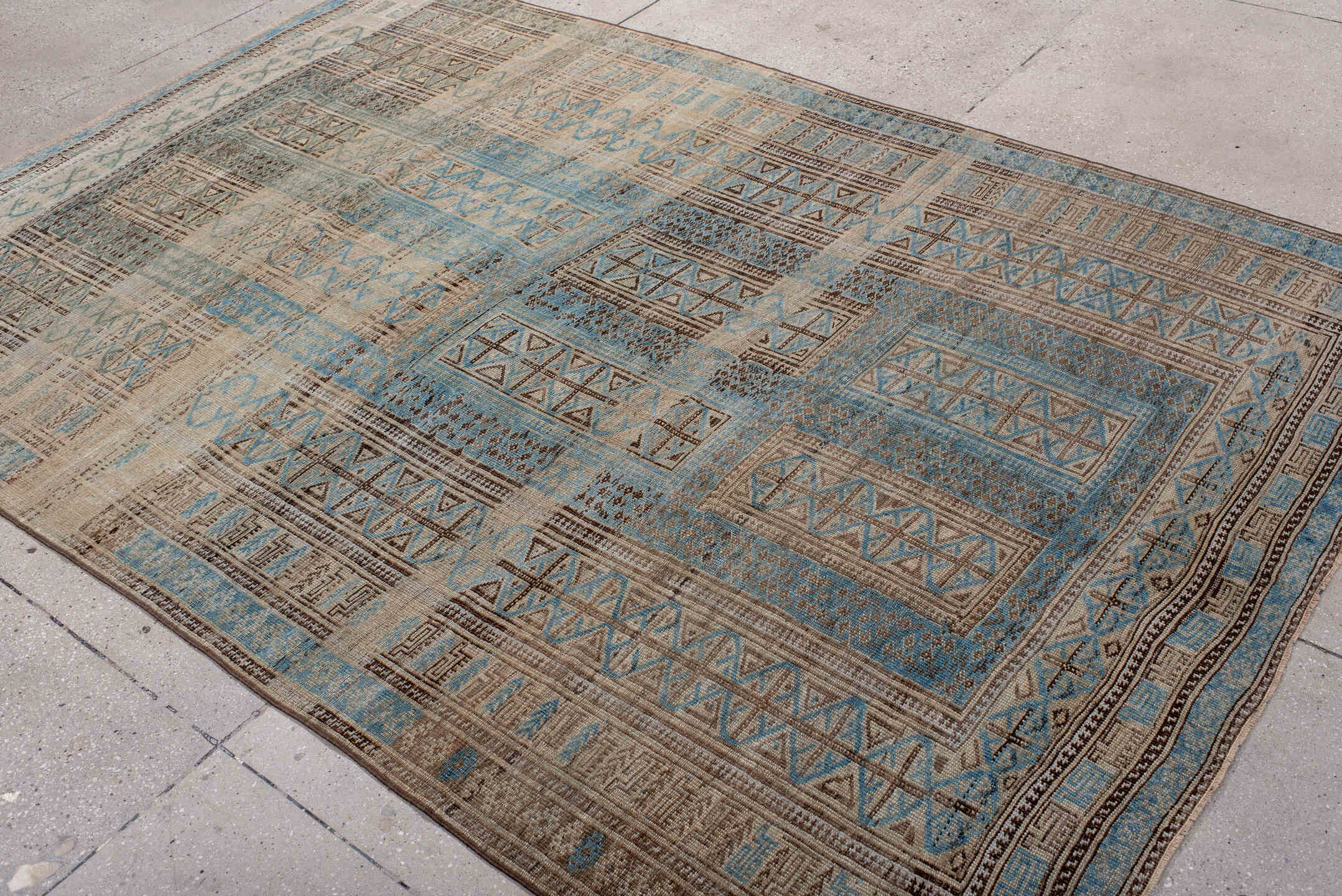 6' x 9' one-of-a-kind handmade antique Belouch medium size rug. Color palette: ivory, sky blue, brown, charcoal, taupe