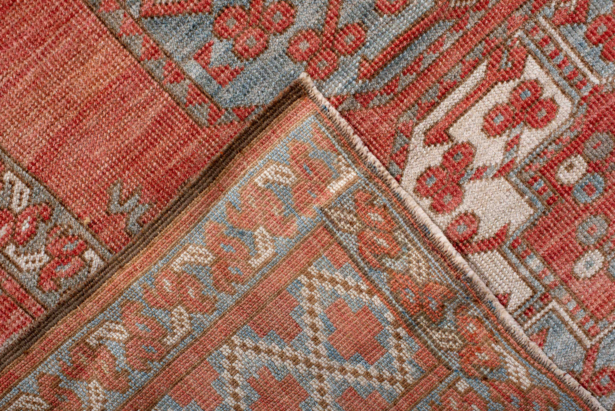 7' x 9' one-of-a-kind handmade antique Afghan rug. Color palette: red, ivory, rust, sky_blue, salmon, terracotta, brown