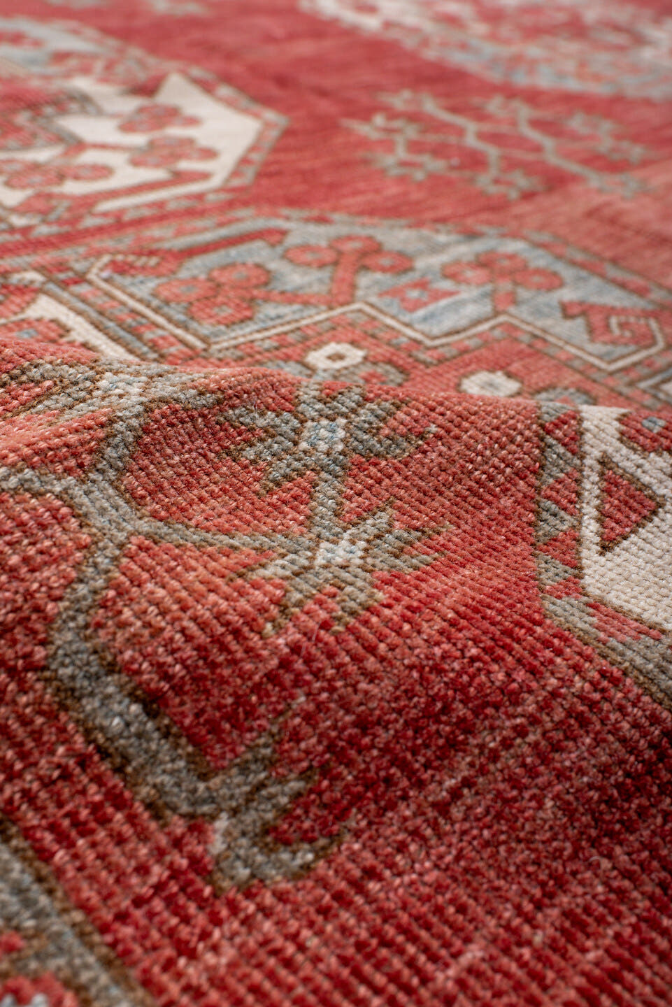 7' x 9' one-of-a-kind handmade antique Afghan rug. Color palette: red, ivory, rust, sky_blue, salmon, terracotta, brown